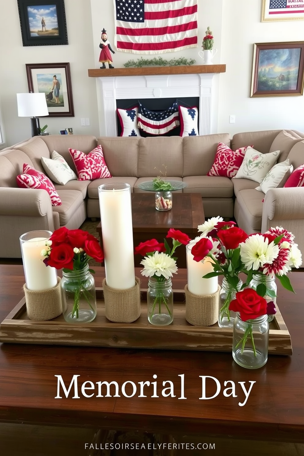 Candle holders wrapped in burlap are placed on a rustic wooden coffee table. Surrounding them are fresh flowers in mason jars, creating a warm and inviting atmosphere for Memorial Day celebrations. A cozy sectional sofa adorned with red, white, and blue throw pillows faces a fireplace. The walls are decorated with patriotic artwork, enhancing the festive spirit of the living room.