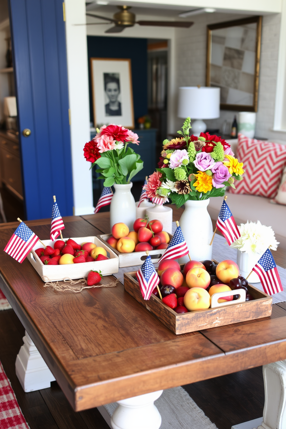 A stylish loft space decorated for Memorial Day features a rustic wooden table adorned with decorative trays filled with vibrant summer fruits such as strawberries, peaches, and cherries. The trays are arranged alongside small American flags and seasonal flowers, creating a festive and inviting atmosphere.