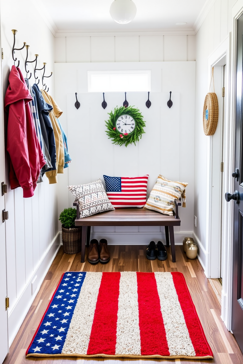 A rustic wooden sign displays a heartfelt Memorial Day message, surrounded by vibrant red, white, and blue decorations. The sign is adorned with delicate floral accents, adding a touch of warmth to the entryway. The mudroom is decorated with patriotic elements, featuring a cozy bench with striped cushions and a collection of stars and stripes throw pillows. A vintage-style rug in red complements the overall theme, while hooks on the wall hold up festive wreaths and seasonal accessories.