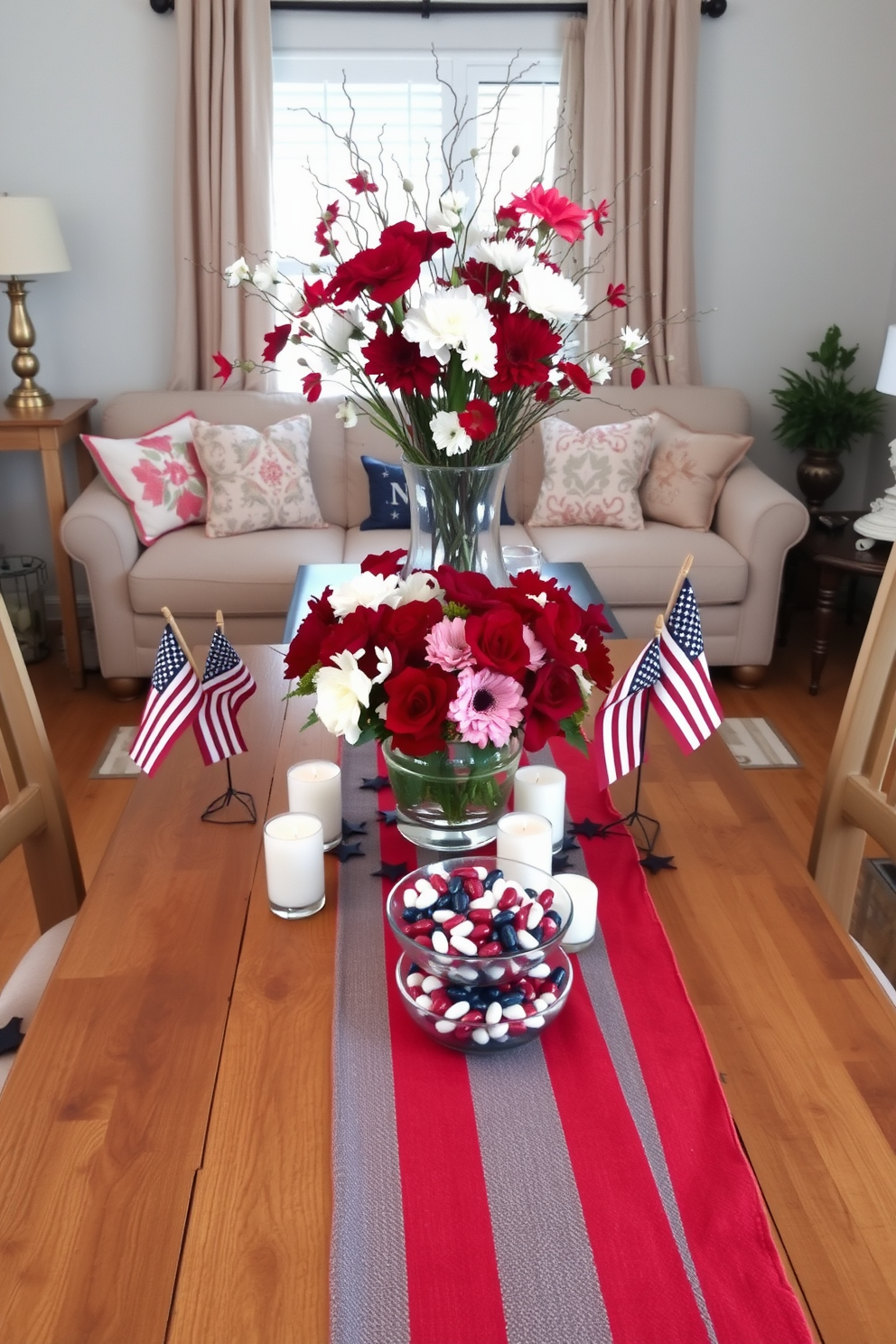 A patriotic themed table centerpiece featuring a rustic wooden table adorned with a vibrant red white and blue table runner. At the center, a large glass vase filled with fresh seasonal flowers in red and white hues surrounded by small American flags and decorative stars. The small living room is decorated with cozy seating arrangements in neutral tones complemented by throw pillows in patriotic colors. A coffee table is topped with a collection of festive candles and a small decorative bowl filled with red white and blue candies.