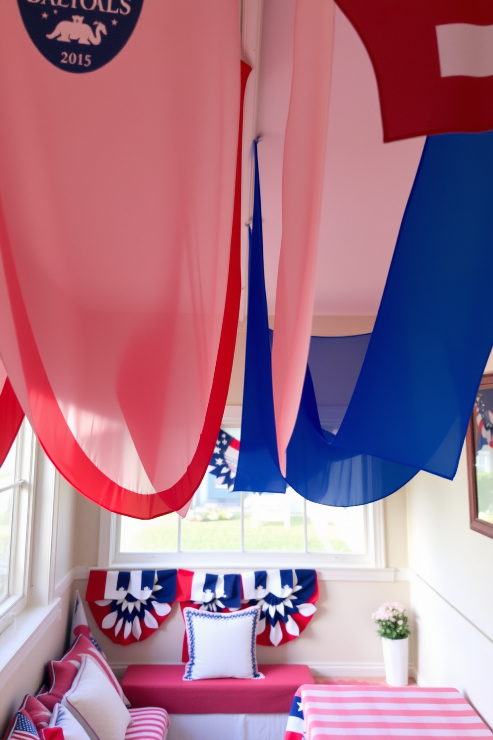 Colorful banners hang from the ceiling, creating a festive atmosphere for a Memorial Day celebration. The small space is decorated with red, white, and blue accents, including cushions and tablecloths that complement the vibrant banners.