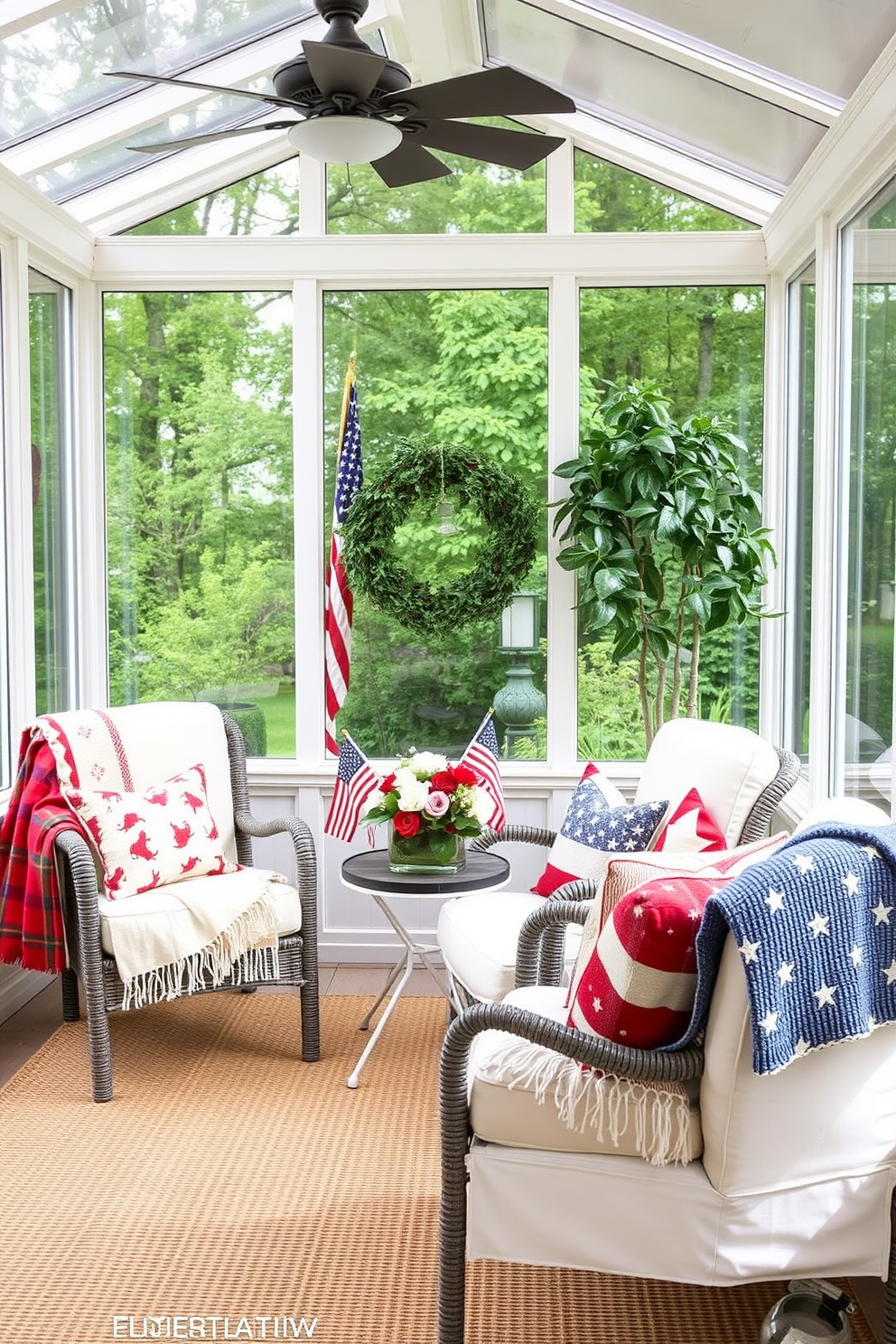 A sunroom filled with natural light features a cozy seating area with comfortable chairs adorned with seasonal throw blankets in red, white, and blue hues. The decor includes patriotic accents like small flags and a centerpiece of fresh flowers, creating a festive atmosphere perfect for Memorial Day gatherings.