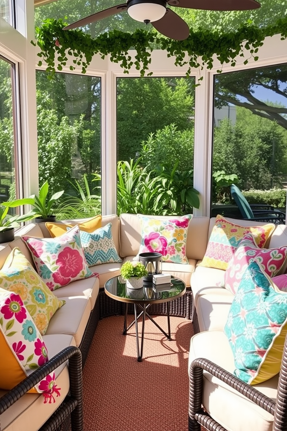 Colorful outdoor pillows are arranged on a cozy seating area in a sunroom, creating a vibrant and inviting atmosphere. The pillows feature a mix of floral and geometric patterns in bright hues, complementing the natural light streaming through the large windows. The sunroom is adorned with lush greenery, adding a refreshing touch to the decor. A stylish coffee table sits at the center, surrounded by comfortable seating, making it the perfect spot for relaxation during Memorial Day celebrations.