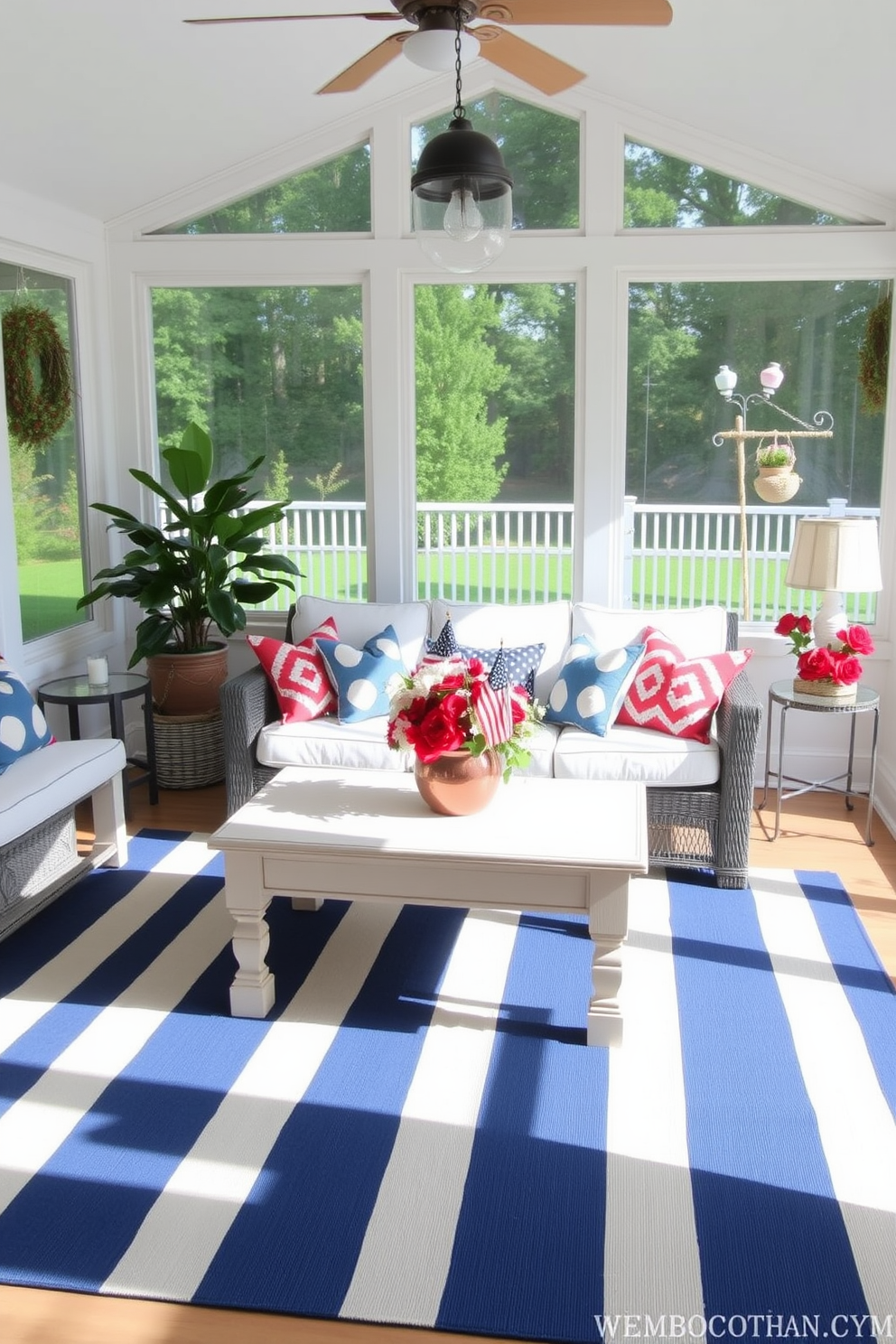 A bright and airy sunroom decorated for Memorial Day features a blue and white striped rug that adds a nautical touch to the space. Comfortable seating is arranged around a central coffee table adorned with red, white, and blue accents, creating a festive atmosphere for relaxation and gatherings.