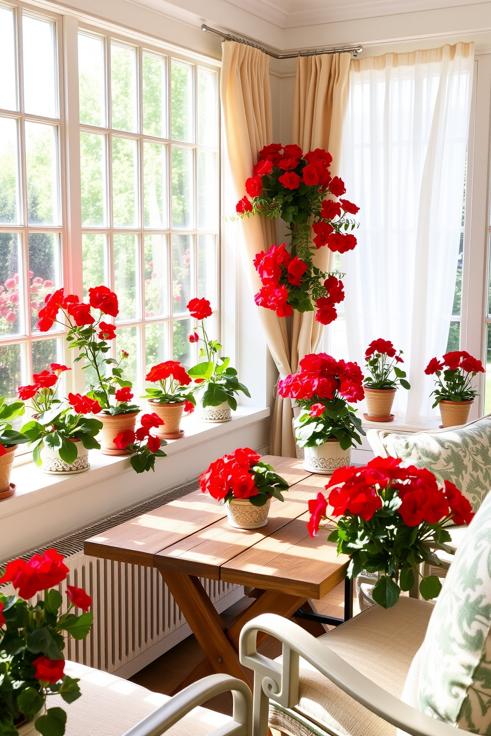 A bright sunroom filled with natural light features a collection of red geraniums in decorative pots arranged along the windowsills. The pots are crafted from ceramic with intricate patterns, adding a touch of elegance to the vibrant blooms. Cozy seating is arranged around a rustic wooden table, inviting relaxation and conversation. Soft, airy curtains flutter gently in the breeze, enhancing the cheerful atmosphere of this Memorial Day-inspired space.