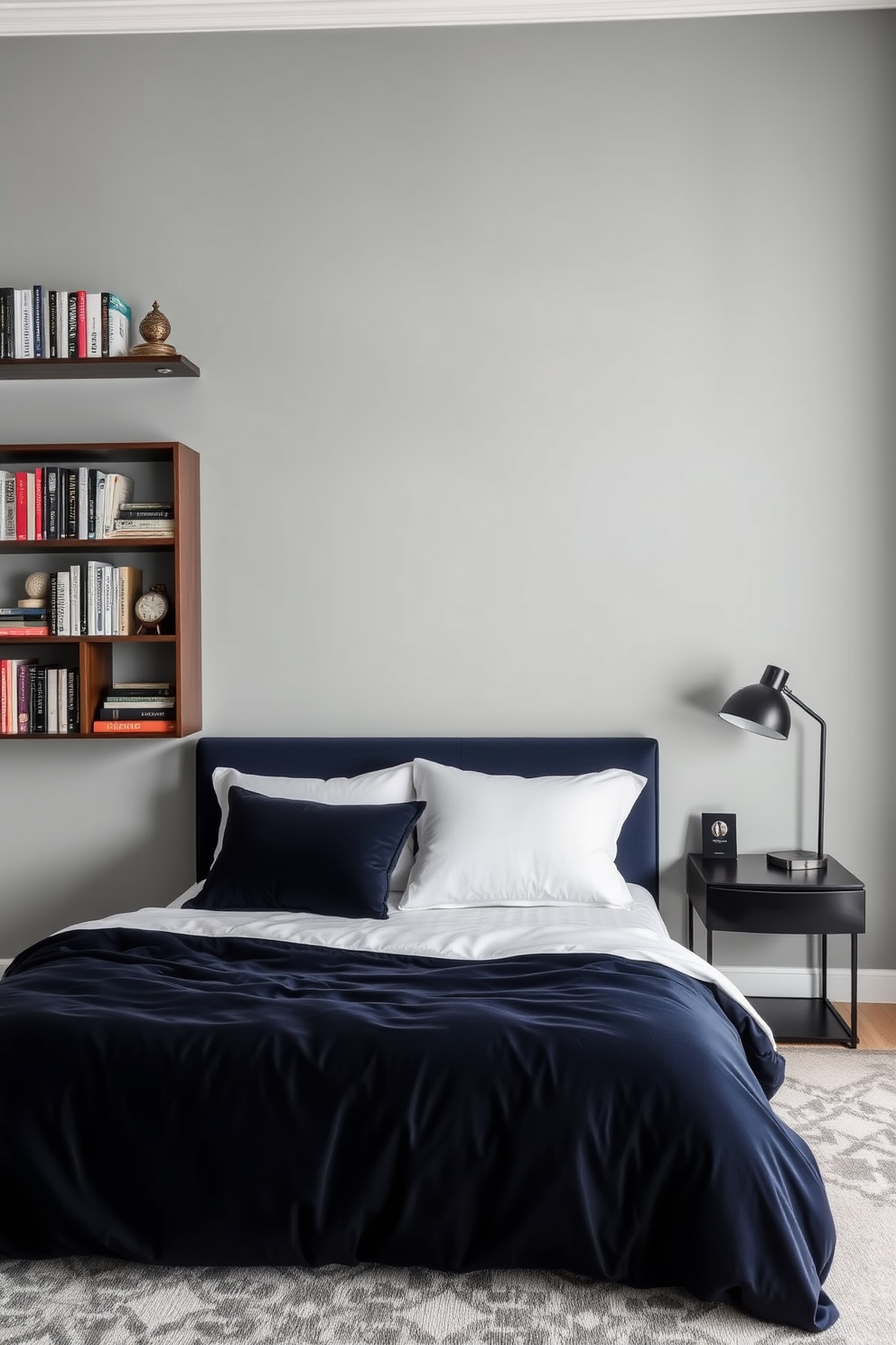 A stylish men's bedroom featuring open shelving that showcases an array of books and decorative items. The shelves are made of dark wood and are neatly arranged against a light gray wall, creating a striking contrast. The bed is dressed in luxurious linens with a deep navy blue duvet and crisp white pillows. A modern bedside table holds a sleek lamp and a few personal items, adding to the overall sophistication of the space.