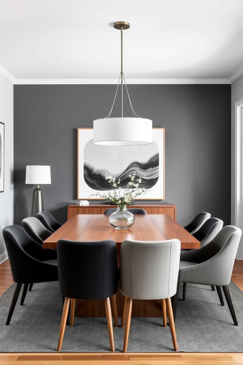 A Mid Century Modern dining room featuring a monochromatic color scheme with varied shades of gray. The room includes a sleek wooden dining table surrounded by upholstered chairs in different shades of gray, complemented by a statement light fixture overhead.