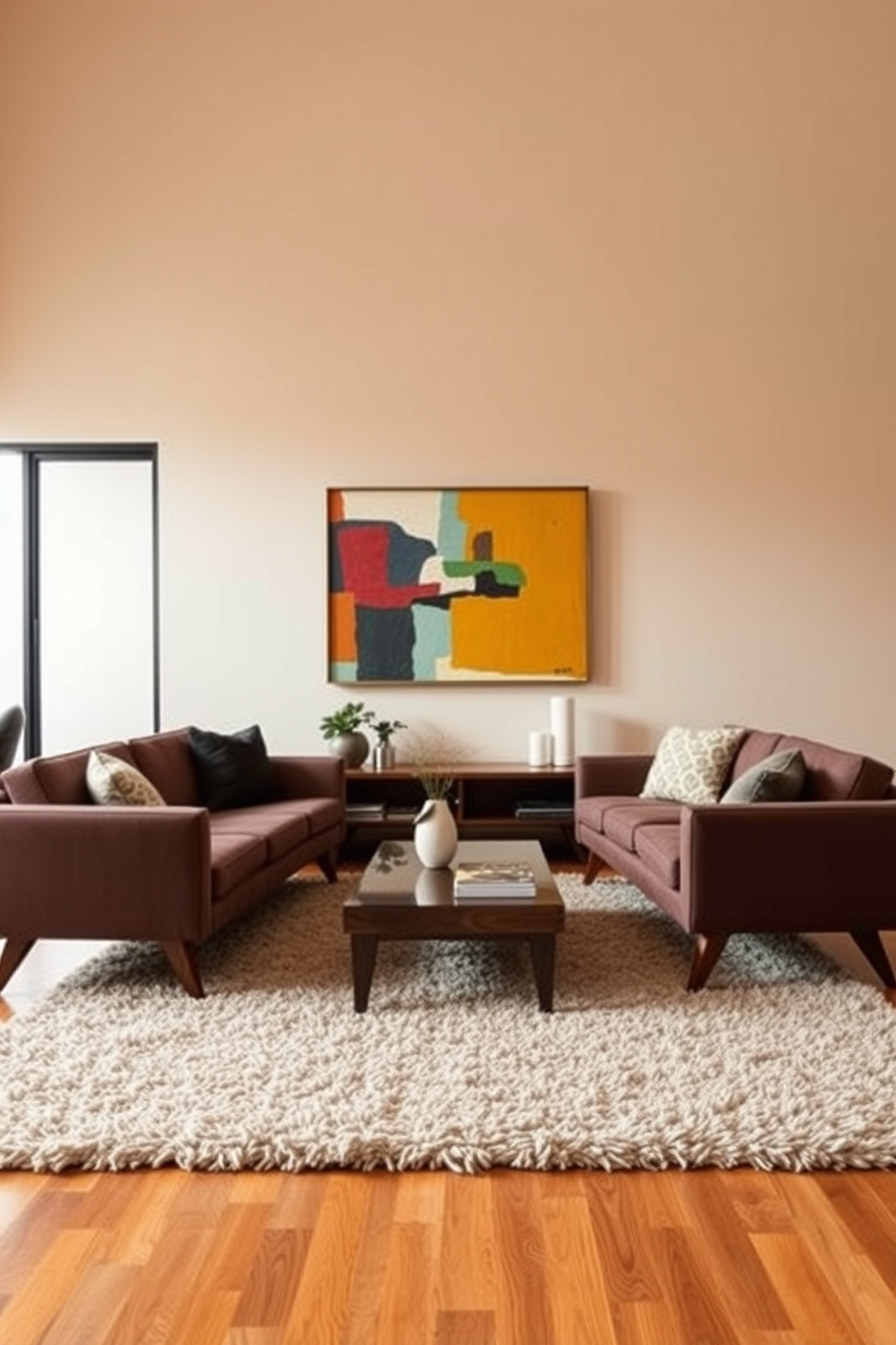 A stylish mid century modern living room featuring two sleek sofas with tapered legs positioned around a low coffee table. The walls are painted in a soft beige, accented by colorful abstract art and a plush area rug that ties the space together.