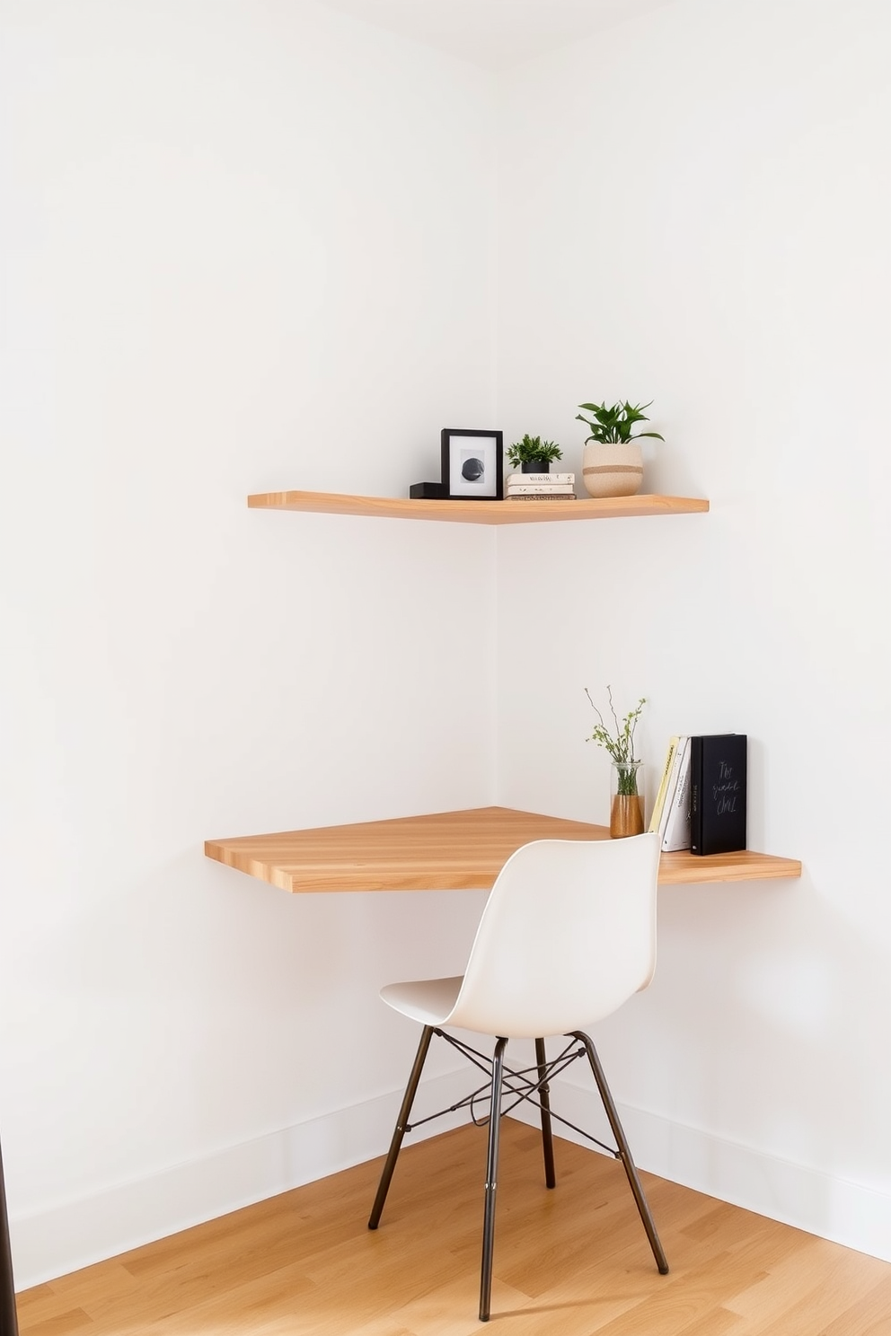 A sleek wall-mounted desk is positioned in the corner of the room, featuring clean lines and a natural wood finish. Above the desk, open shelving displays a few curated decorative items and plants, enhancing the minimalist aesthetic. The walls are painted in a soft white color, creating a bright and airy atmosphere. A simple, comfortable chair complements the desk, providing a functional yet stylish workspace without occupying valuable floor space.