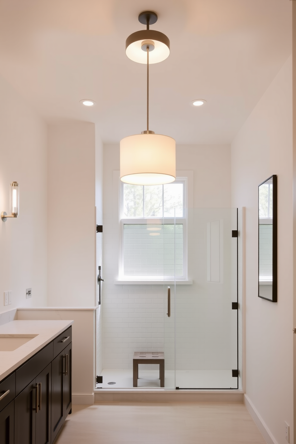 Elegant pendant lighting serves as the focal point in this minimalist bathroom design. The soft glow from the fixtures enhances the serene atmosphere, creating a perfect blend of functionality and style. The walls are adorned with a calming neutral palette, while sleek cabinetry offers ample storage without compromising the open feel. A spacious walk-in shower features frameless glass doors, allowing natural light to flood the space.