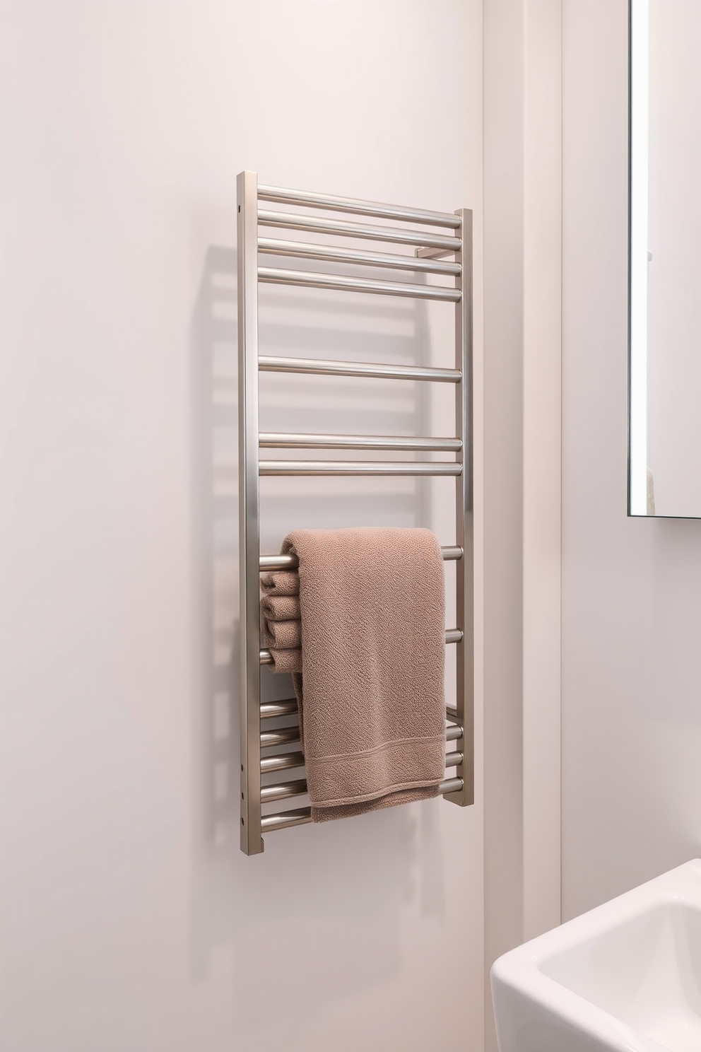 A sleek towel rack seamlessly integrates into the decor of a minimalist bathroom. The design features clean lines and a neutral color palette, enhancing the overall simplicity of the space. The towel rack is mounted on the wall, made from brushed stainless steel for a modern touch. Soft, fluffy towels in muted tones are neatly arranged, adding a subtle pop of color while maintaining the minimalist aesthetic.