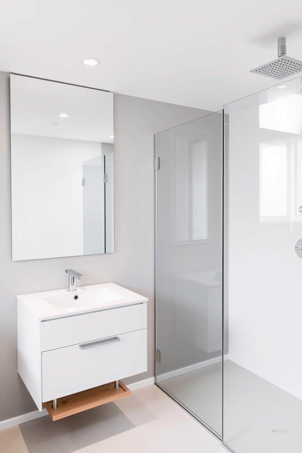 A minimalist bathroom featuring a large mirror that enhances light reflection. The space includes a sleek white vanity with a single sink and a simple wooden shelf for storage. The walls are painted in a soft gray hue, creating a calm and serene atmosphere. A glass shower enclosure with a rainfall showerhead complements the modern aesthetic.