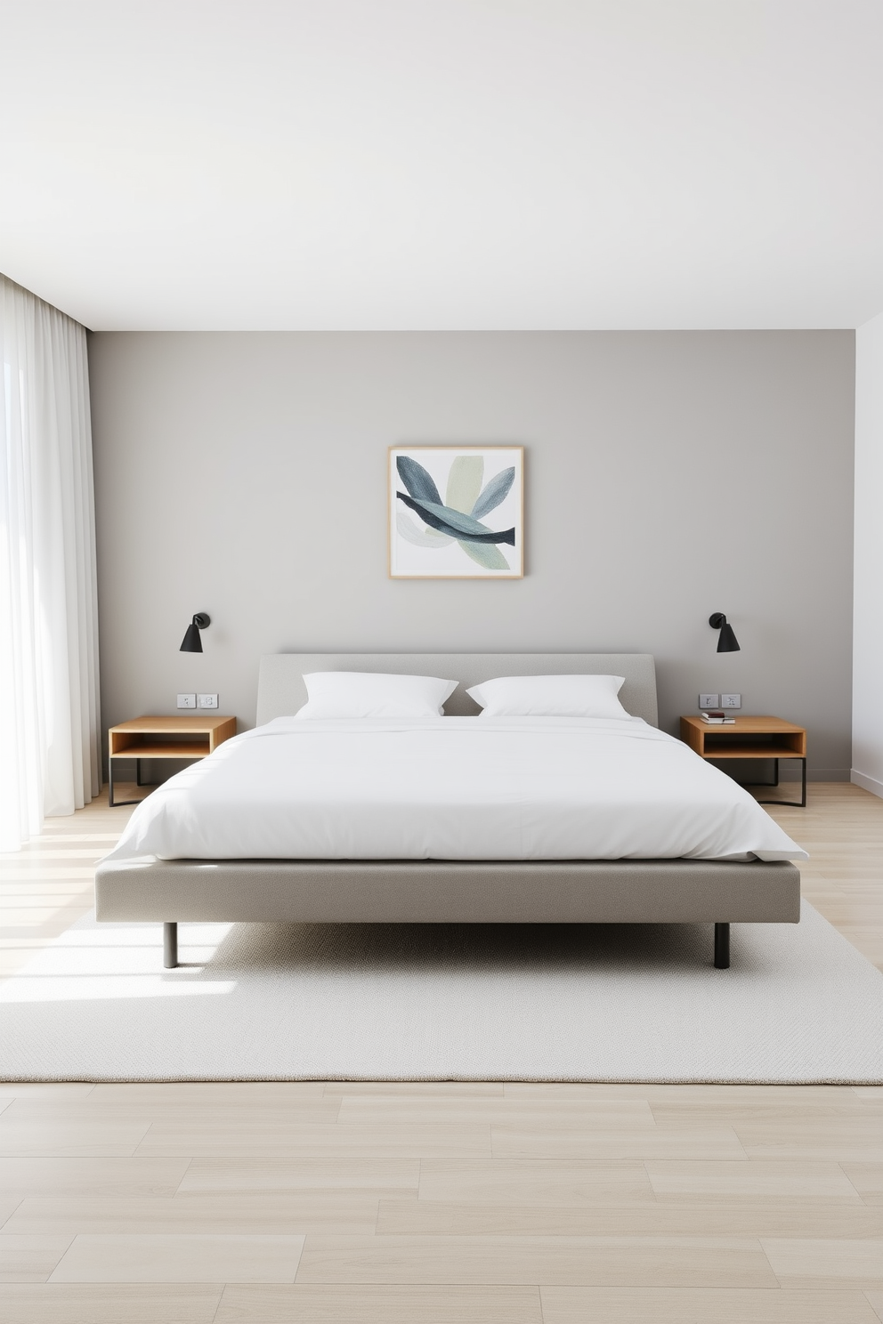 A low-profile bed with a sleek frame sits centered against a soft gray accent wall. The bedding is crisp white with subtle textures, complemented by two minimalist nightstands on either side. Natural light floods the room through sheer curtains, illuminating a simple geometric rug beneath the bed. A single piece of abstract art hangs above the bed, enhancing the room's tranquil atmosphere.