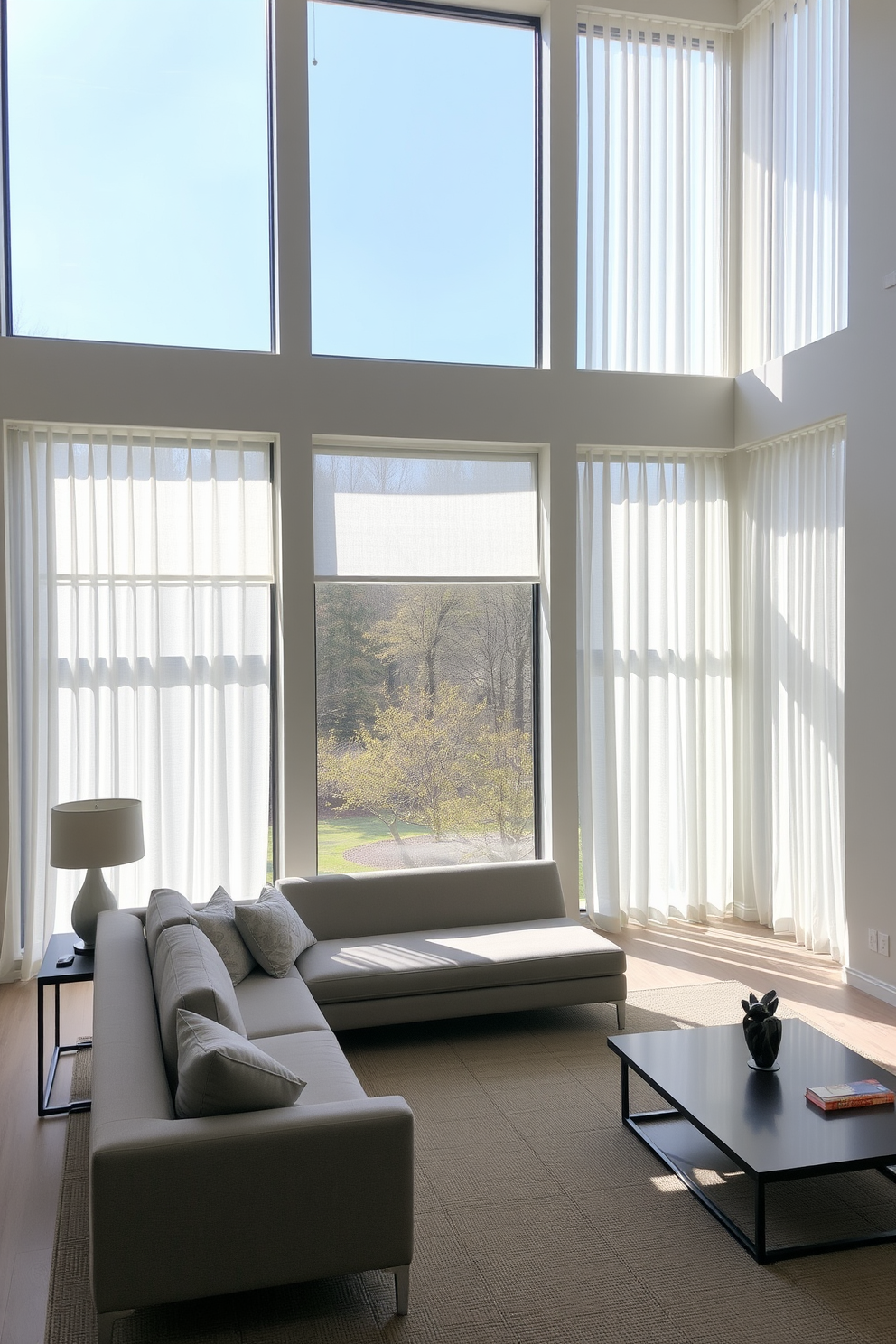 A serene family room with large windows that allow natural light to flood the space. The window treatments are simple sheer curtains that gently frame the windows, providing unobstructed views of the outdoors. The room features a minimalist design with a neutral color palette and clean lines. A low-profile sofa in soft gray is complemented by a sleek coffee table and a few carefully selected decorative accents.