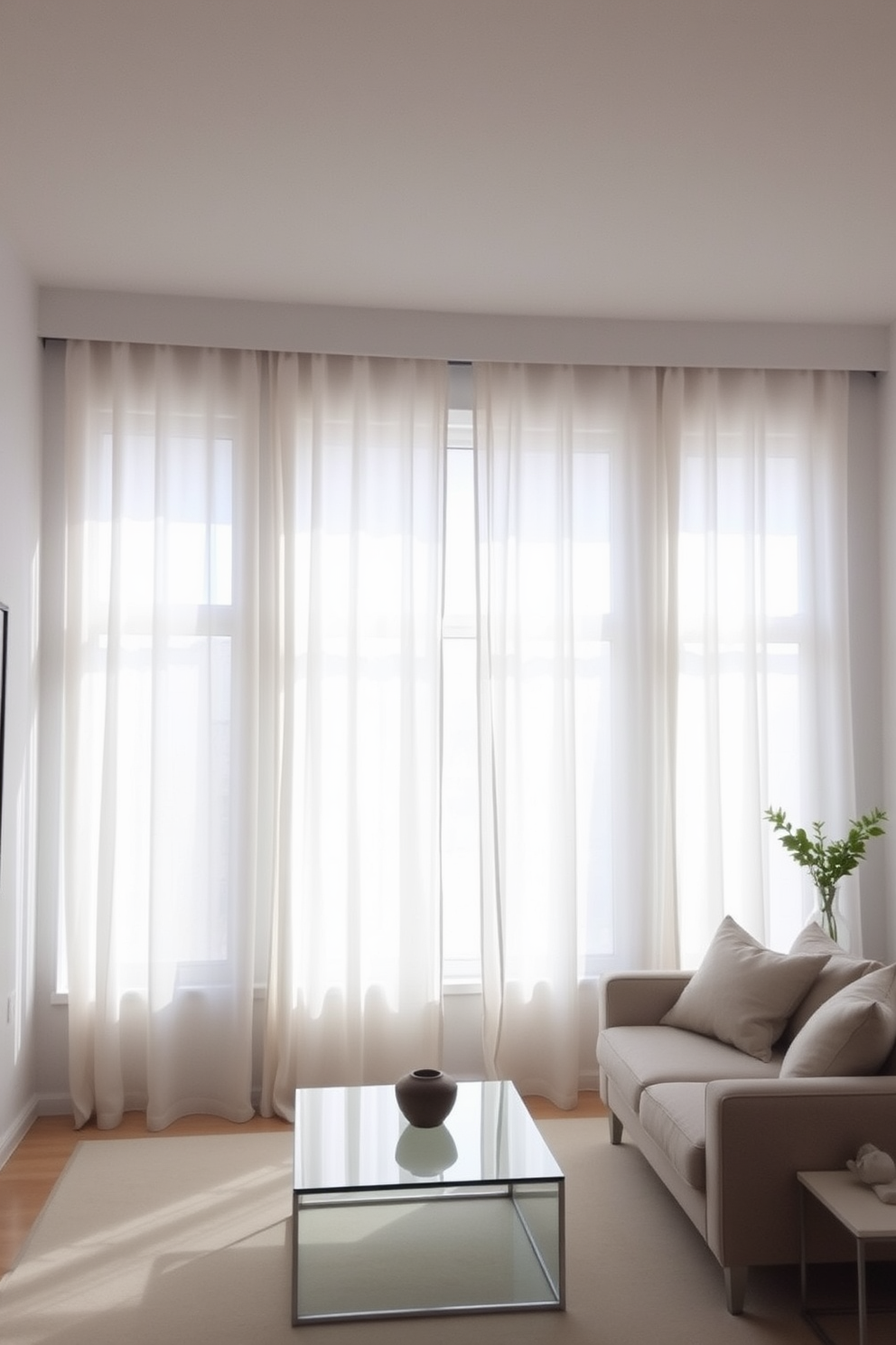 A serene living room featuring minimalist window treatments that allow natural light to flood the space. The curtains are sheer and light-colored, seamlessly blending with the neutral walls and enhancing the overall simplicity of the design. The room includes a low-profile sofa in a soft fabric, paired with a sleek coffee table made of glass and metal. A few carefully chosen decorative elements, such as a single plant and a minimalist art piece, complete the understated elegance of the space.