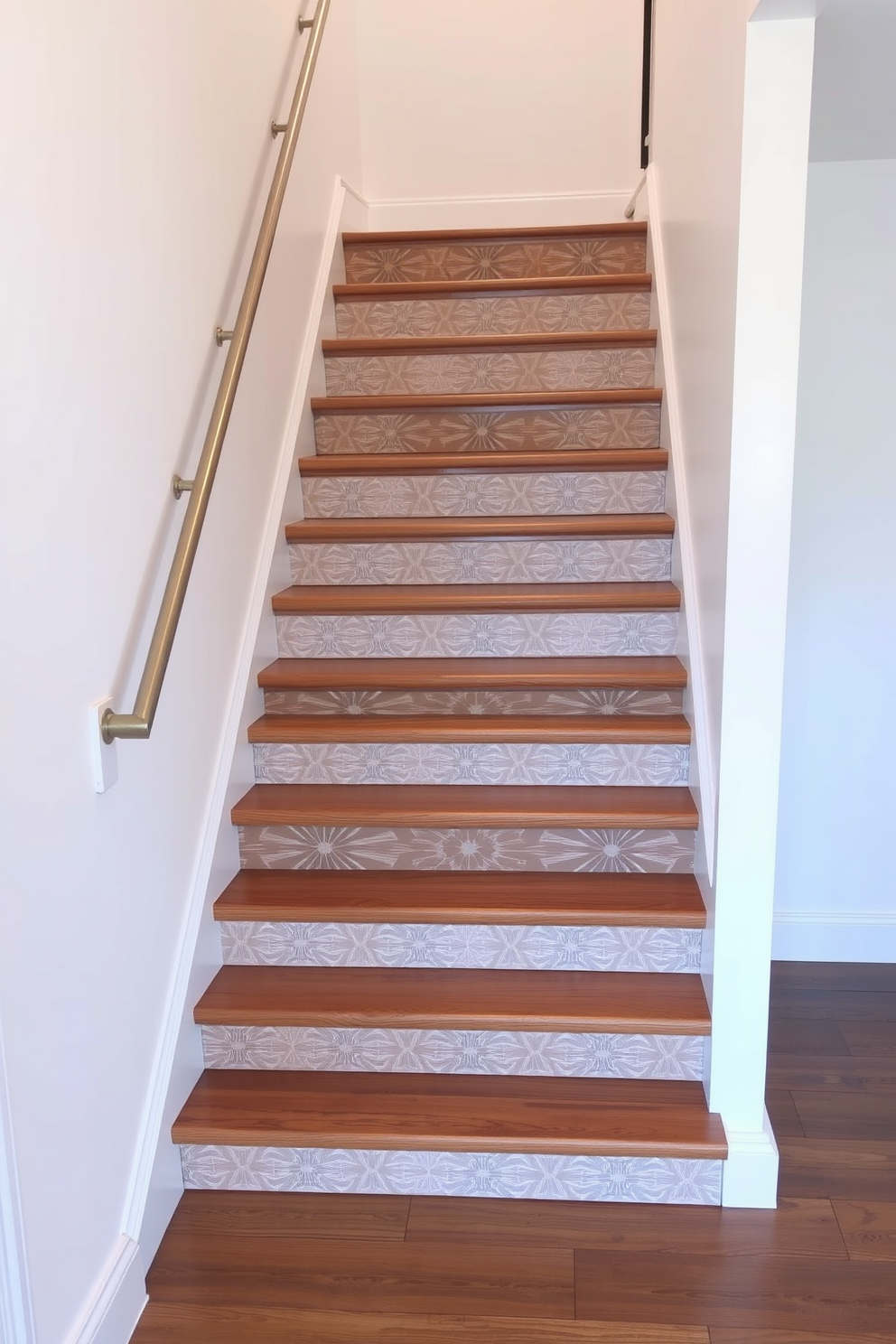 A stunning staircase featuring unique patterned risers that add a touch of personality to the design. The risers showcase a mix of geometric patterns in subtle colors, creating a visual interest against the sleek wooden treads. The handrail is a simple yet elegant metal design, complementing the clean lines of the staircase. Surrounding the staircase, the walls are painted in a soft white, enhancing the minimalist aesthetic and allowing the patterned risers to stand out.