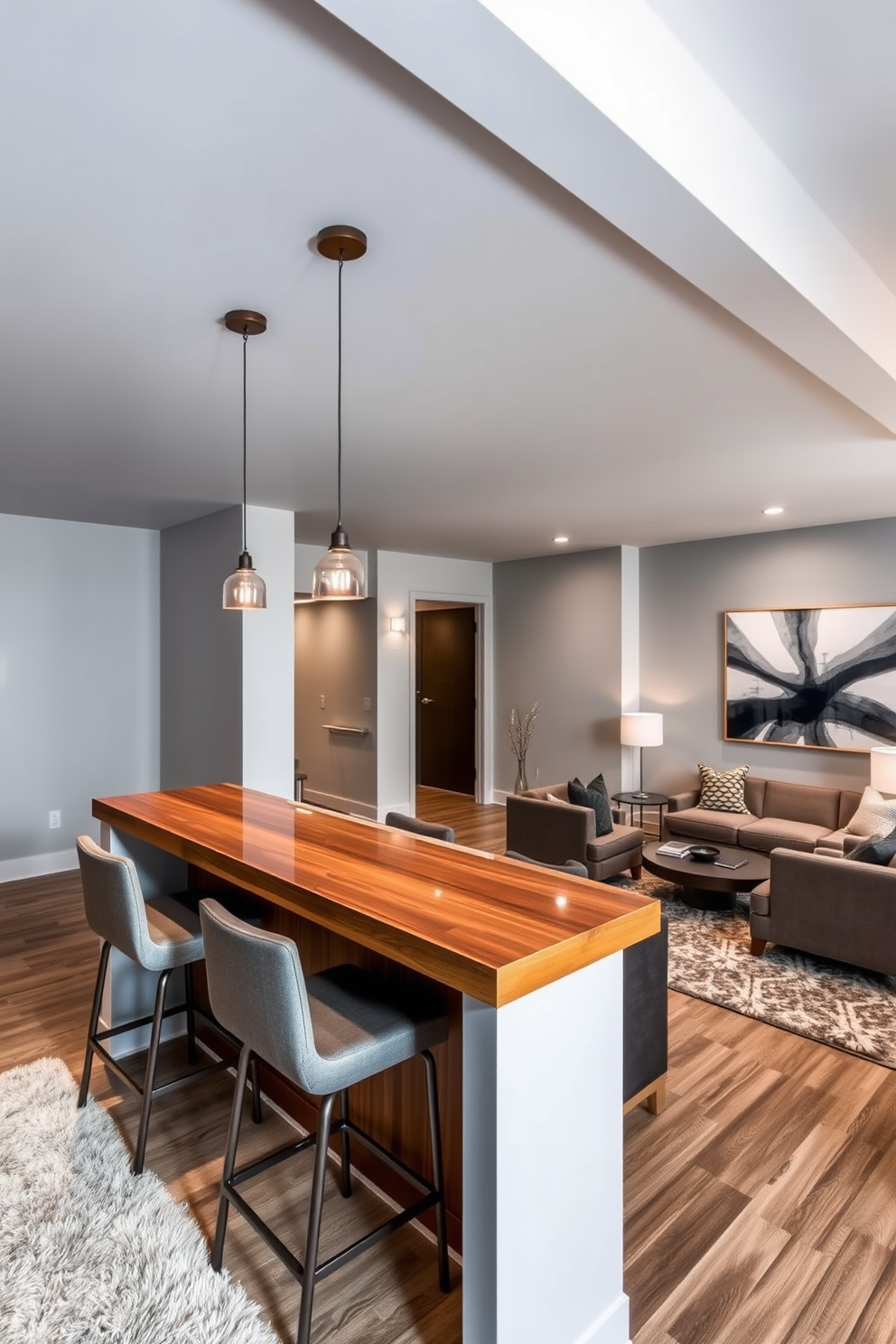 Stylish bar area with high-top stools. The space features a sleek wooden bar with a polished countertop, illuminated by pendant lights hanging above. Modern basement design ideas include an open layout with comfortable seating arrangements. The walls are painted in a light gray tone, complemented by a plush area rug and contemporary artwork.