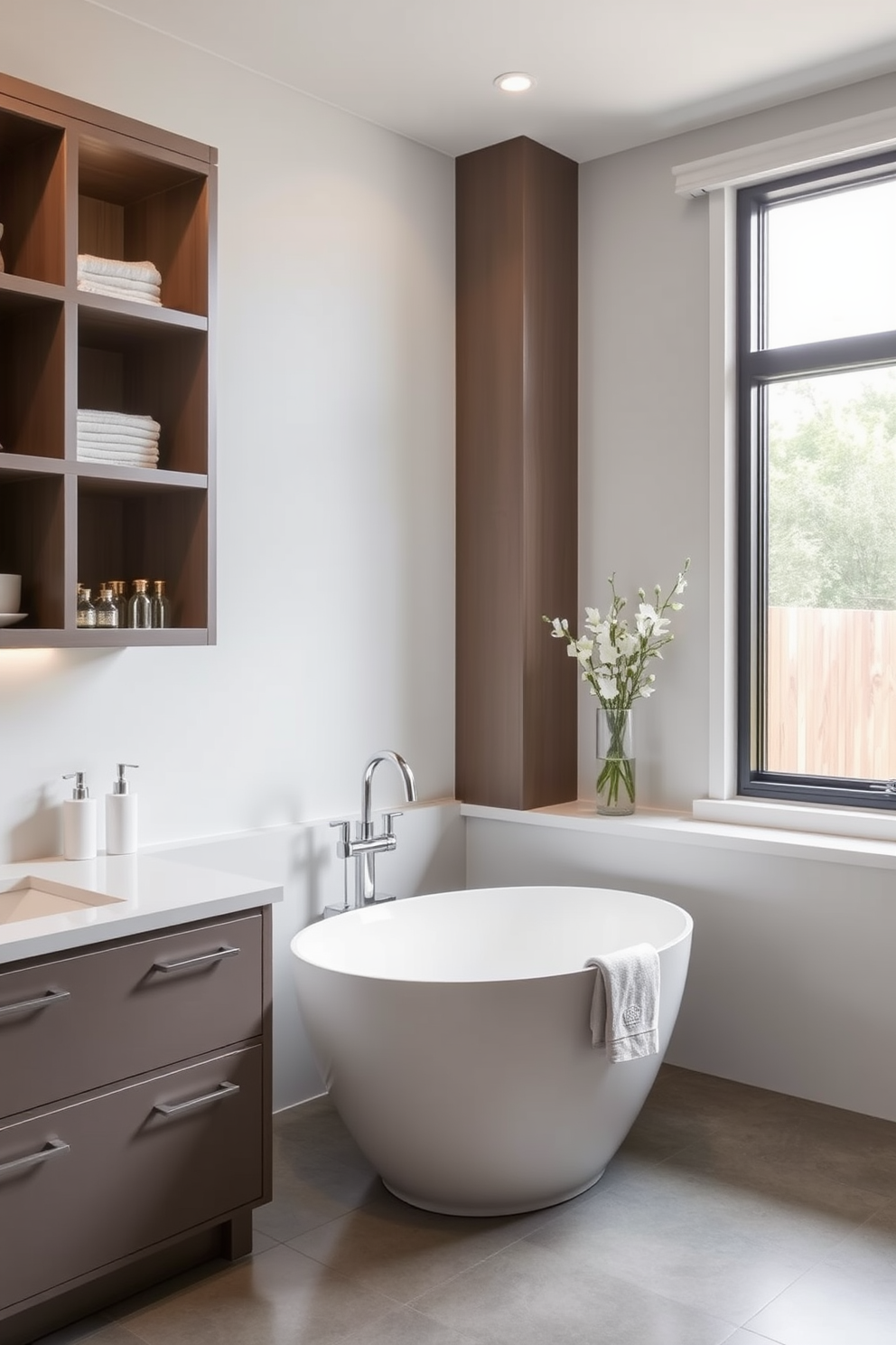 A modern bathroom featuring hexagonal tiles in varying shades of gray and white for a stylish flair. The space includes a sleek freestanding bathtub positioned under a large window, allowing natural light to flood the room. The walls are adorned with contemporary art pieces that complement the tile design. A minimalist wooden shelf holds neatly arranged towels and decorative items, enhancing the overall aesthetic.