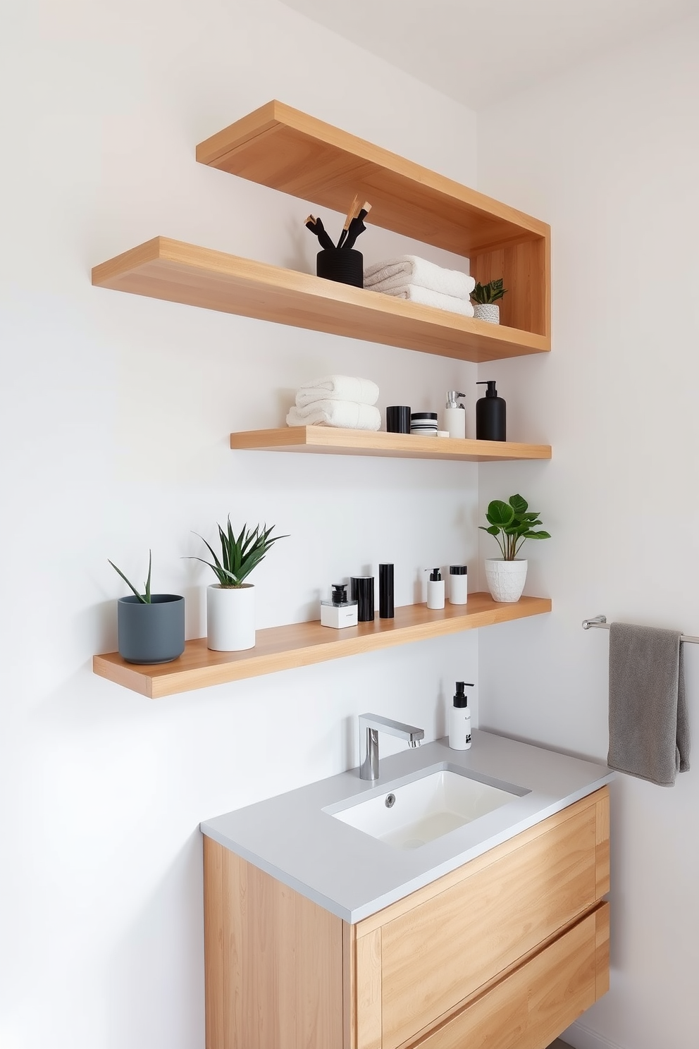 A modern bathroom features sleek floating shelves made of light wood, providing stylish storage for towels and decorative items. The walls are painted in a crisp white, enhancing the room's brightness and creating a clean, airy atmosphere. The floating shelves are arranged at varying heights, showcasing a mix of potted plants and elegant bath accessories. Below, a contemporary vanity with a polished countertop complements the overall modern aesthetic of the space.