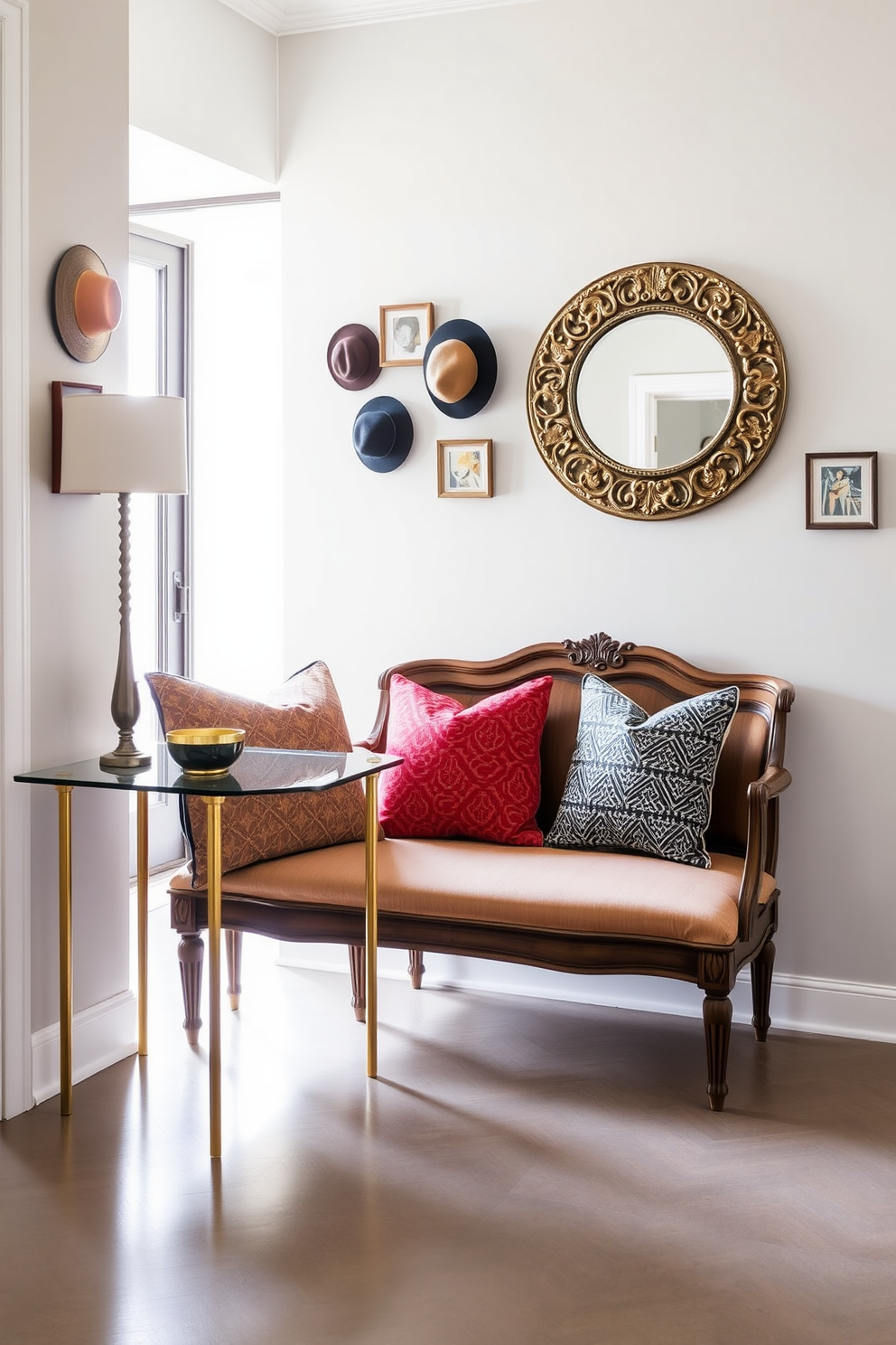 A stylish entryway that blends modern and vintage decor elements. The space features a sleek console table with a glass top and gold legs, paired with an antique wooden bench adorned with colorful cushions. On the wall, a large round mirror with an ornate frame reflects the natural light streaming in through a nearby window. A collection of vintage hats and framed artwork hangs above the bench, adding character and charm to the modern aesthetic.