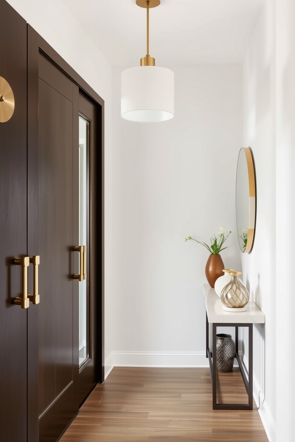 A modern entryway featuring unique door hardware that adds charm and character. The space is illuminated by a stylish pendant light, and a sleek console table sits against the wall, adorned with decorative items.