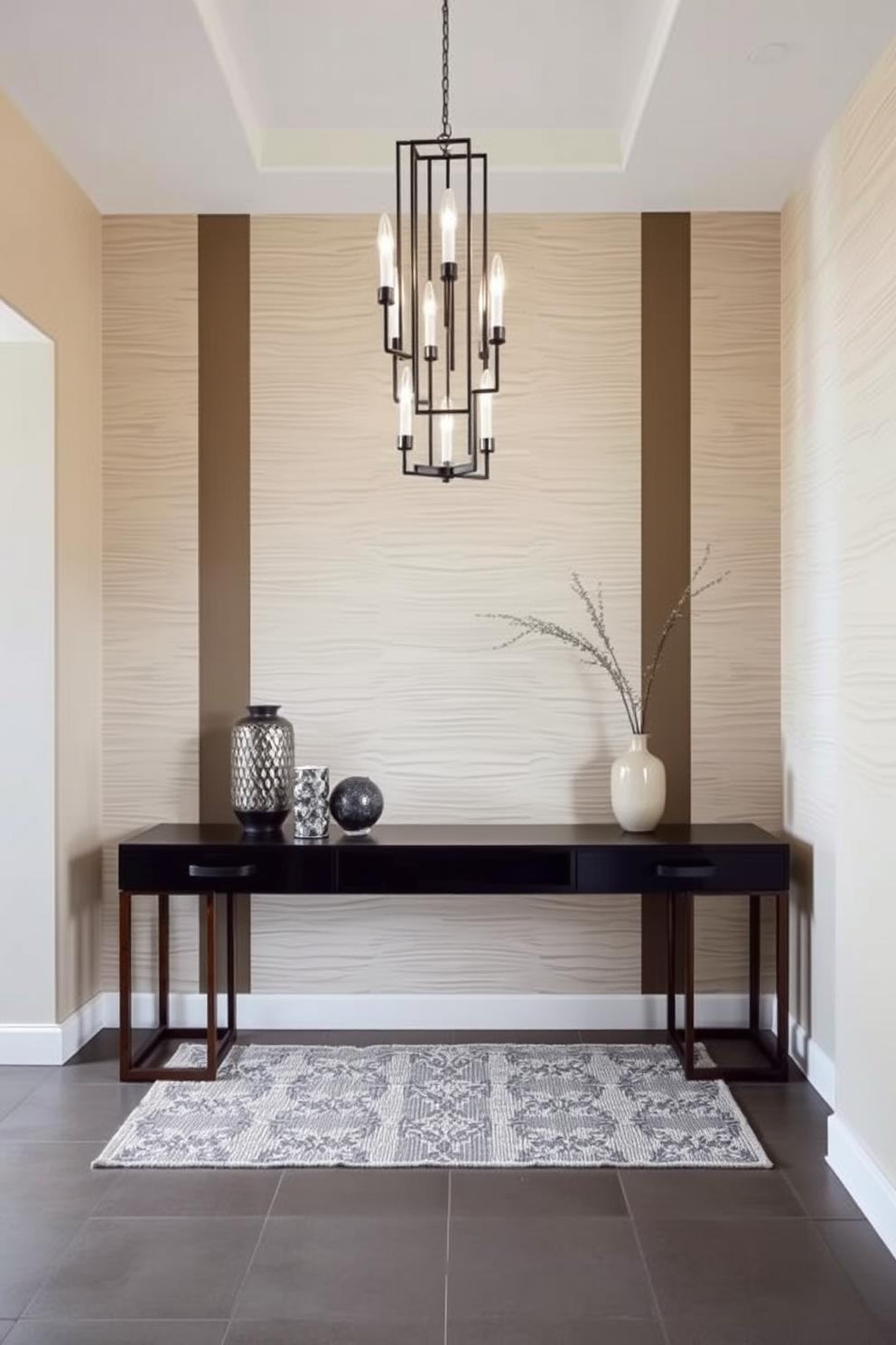 A modern foyer featuring textured wall panels that create visual interest and depth. The space is illuminated by a stylish chandelier, with a sleek console table adorned with decorative accessories.