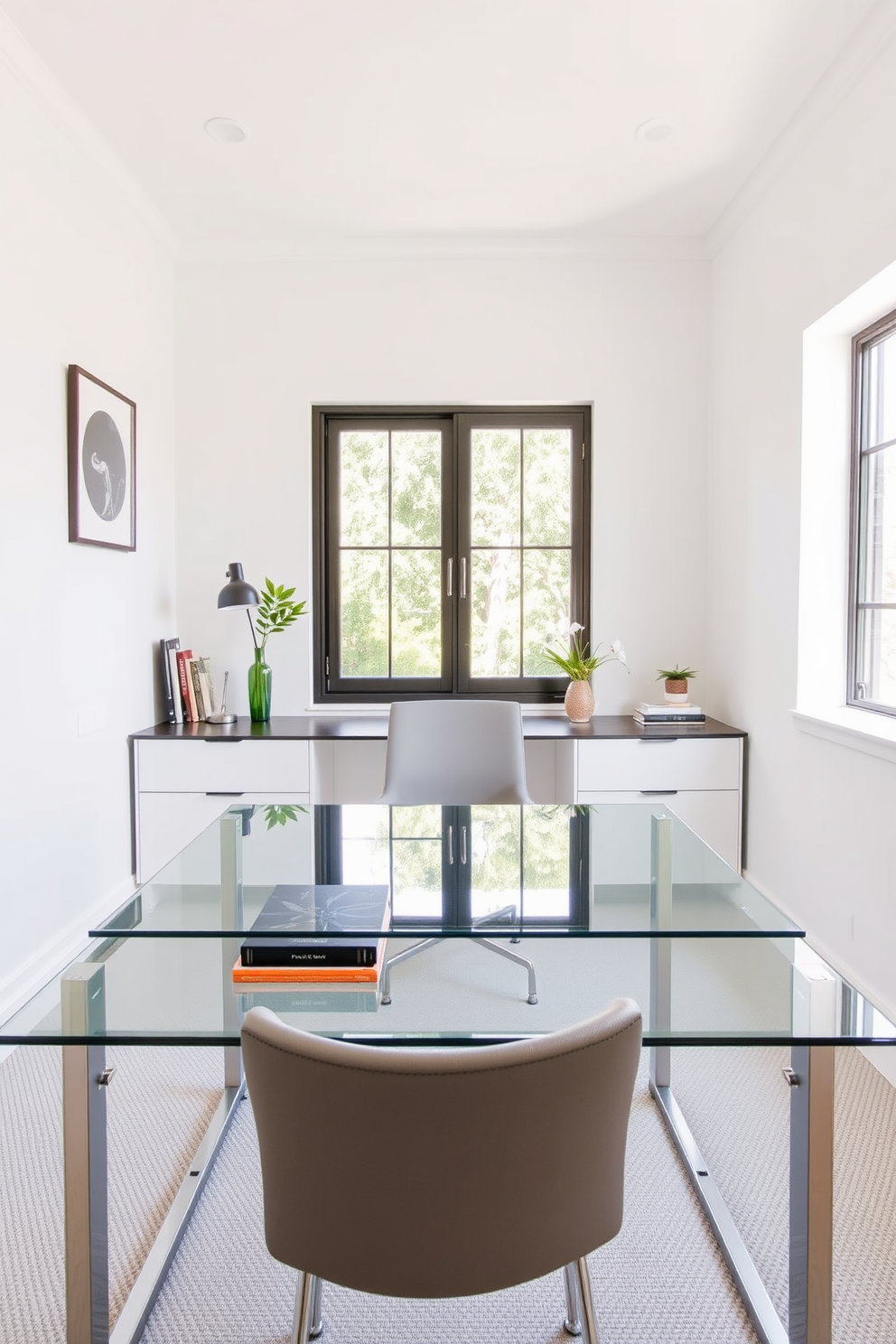 A sleek glass desk sits in the center of a modern home office designed for small spaces. The room features light-colored walls and minimalistic decor, allowing natural light to enhance the airy atmosphere.