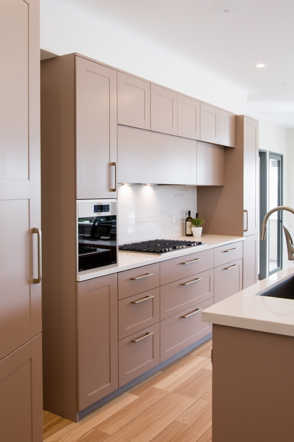 A sleek kitchen featuring cabinetry with clean lines and minimalistic hardware creates an inviting atmosphere. The countertops are made of polished quartz, complementing the overall modern aesthetic with a touch of elegance.