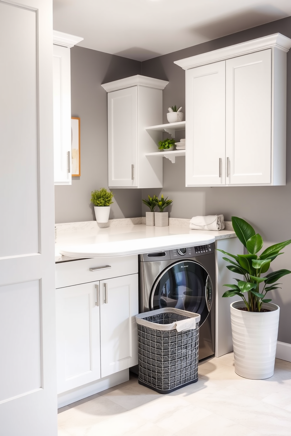 A modern laundry room features a built-in ironing board station seamlessly integrated into the cabinetry for convenience. The space is designed with sleek white cabinets and a quartz countertop, providing ample storage and workspace. The walls are painted in a soft gray, creating a calm atmosphere, while the floor showcases large, light-colored tiles for easy cleaning. A stylish laundry basket sits in the corner, and potted plants add a touch of greenery to the room.