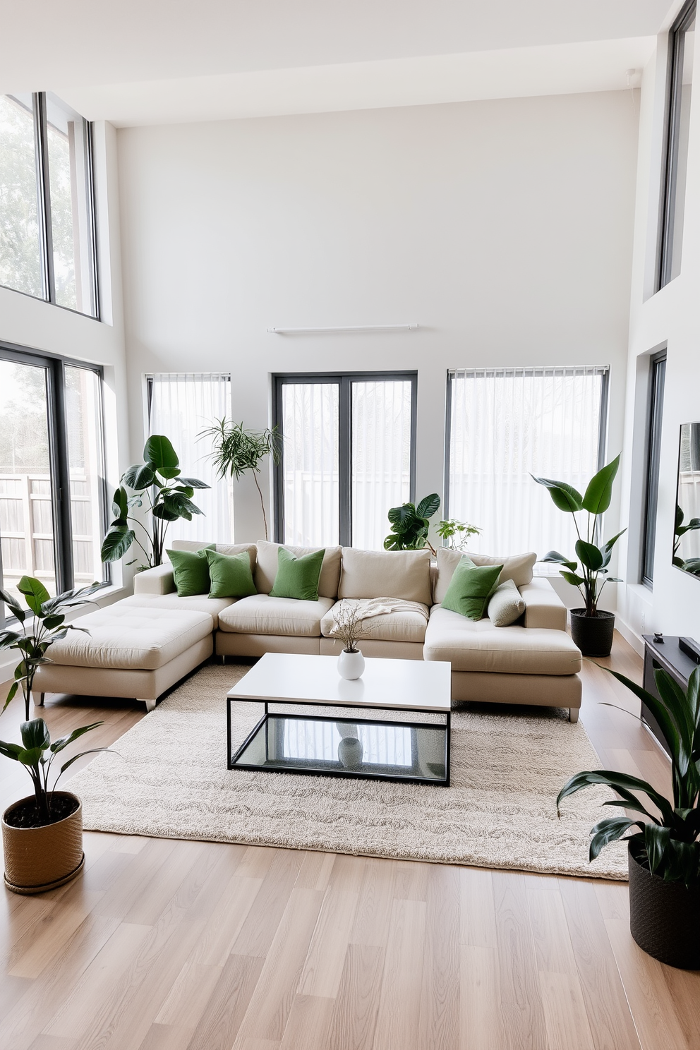 A modern living room featuring a neutral palette with soft beige and gray tones. Large windows allow natural light to flood the space, highlighting a plush sectional sofa adorned with green accent pillows. A sleek coffee table sits in the center, surrounded by a minimalist area rug. Potted plants in various sizes are strategically placed around the room, bringing a refreshing touch of greenery.