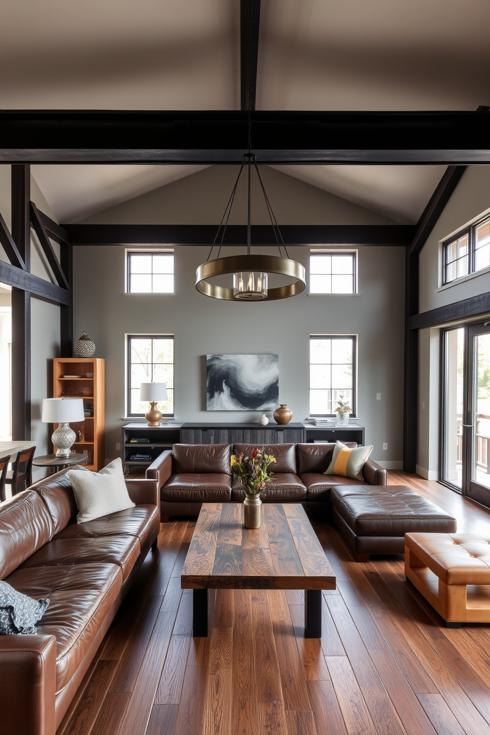 A modern living room featuring industrial accents with exposed metal beams and wooden furniture. The space includes a large leather sofa, a reclaimed wood coffee table, and a statement light fixture made of metal. The walls are painted in a soft gray, complementing the rich tones of the wood. Large windows allow natural light to flood the room, highlighting the mix of textures and materials.