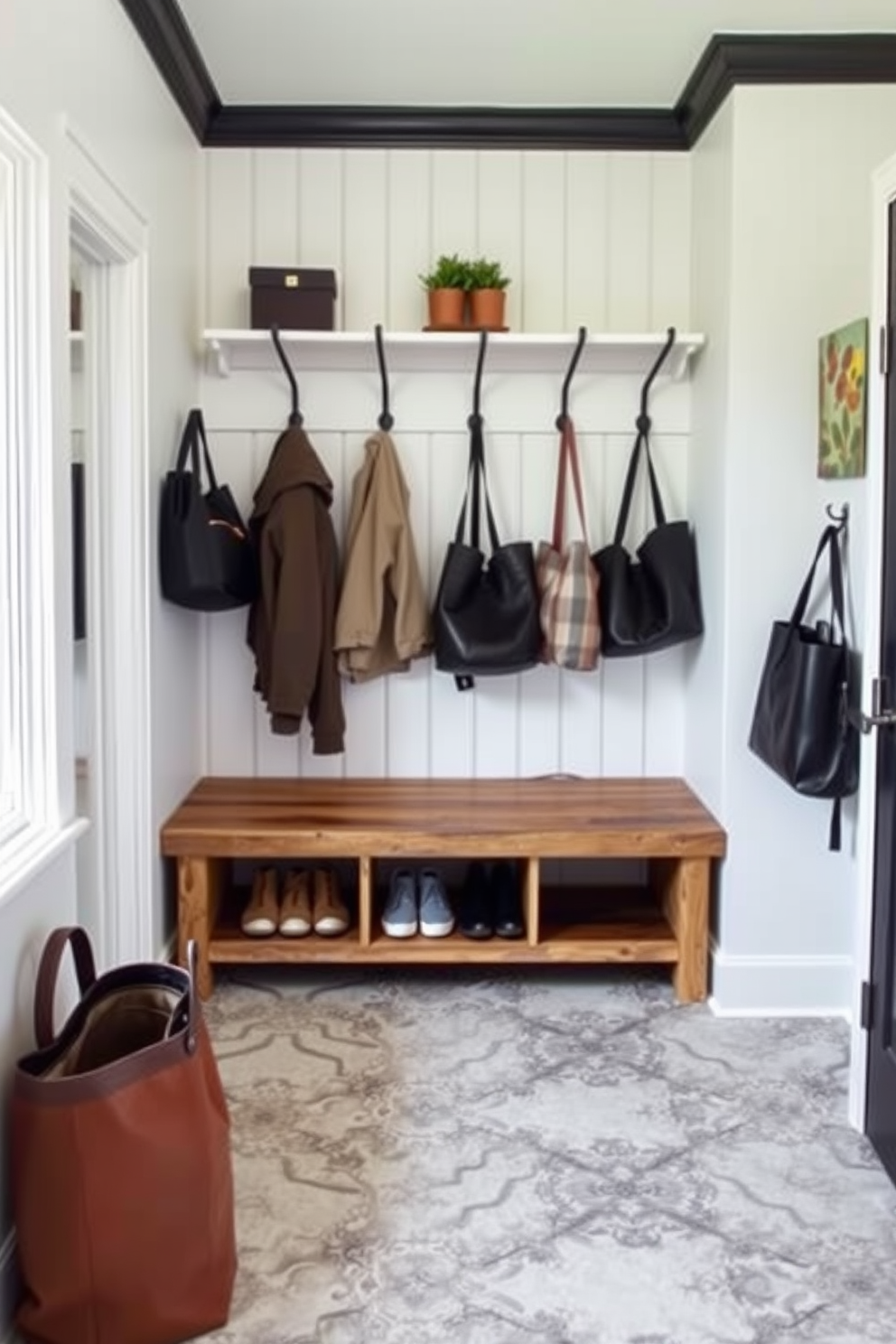 Accent wall with textured wallpaper. The wallpaper features a subtle geometric pattern in soft gray tones, creating a sophisticated backdrop for the space. Modern mudroom design ideas. The mudroom includes built-in benches with storage underneath, complemented by sleek hooks for coats and a stylish area rug that adds warmth.