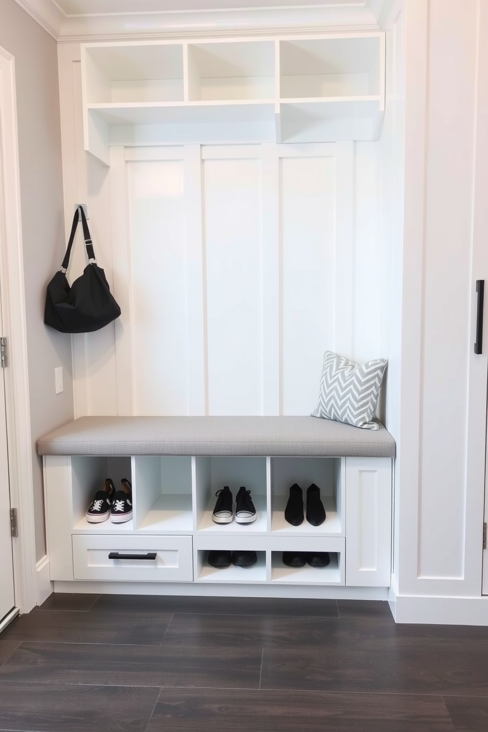 Colorful baskets are arranged neatly on a wooden shelf, providing a stylish solution for organized clutter. The mudroom features a combination of bright hues and natural materials, creating a welcoming and functional space. The walls are painted in a soft gray tone, complementing the vibrant colors of the baskets. A durable bench with built-in storage sits against one wall, adorned with cozy cushions for added comfort.