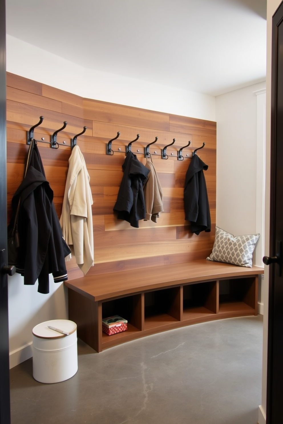 A modern mudroom features wall-mounted hooks for efficient organization, providing a stylish solution for hanging coats and bags. The space is designed with a combination of durable materials and functional storage, ensuring a clutter-free environment.