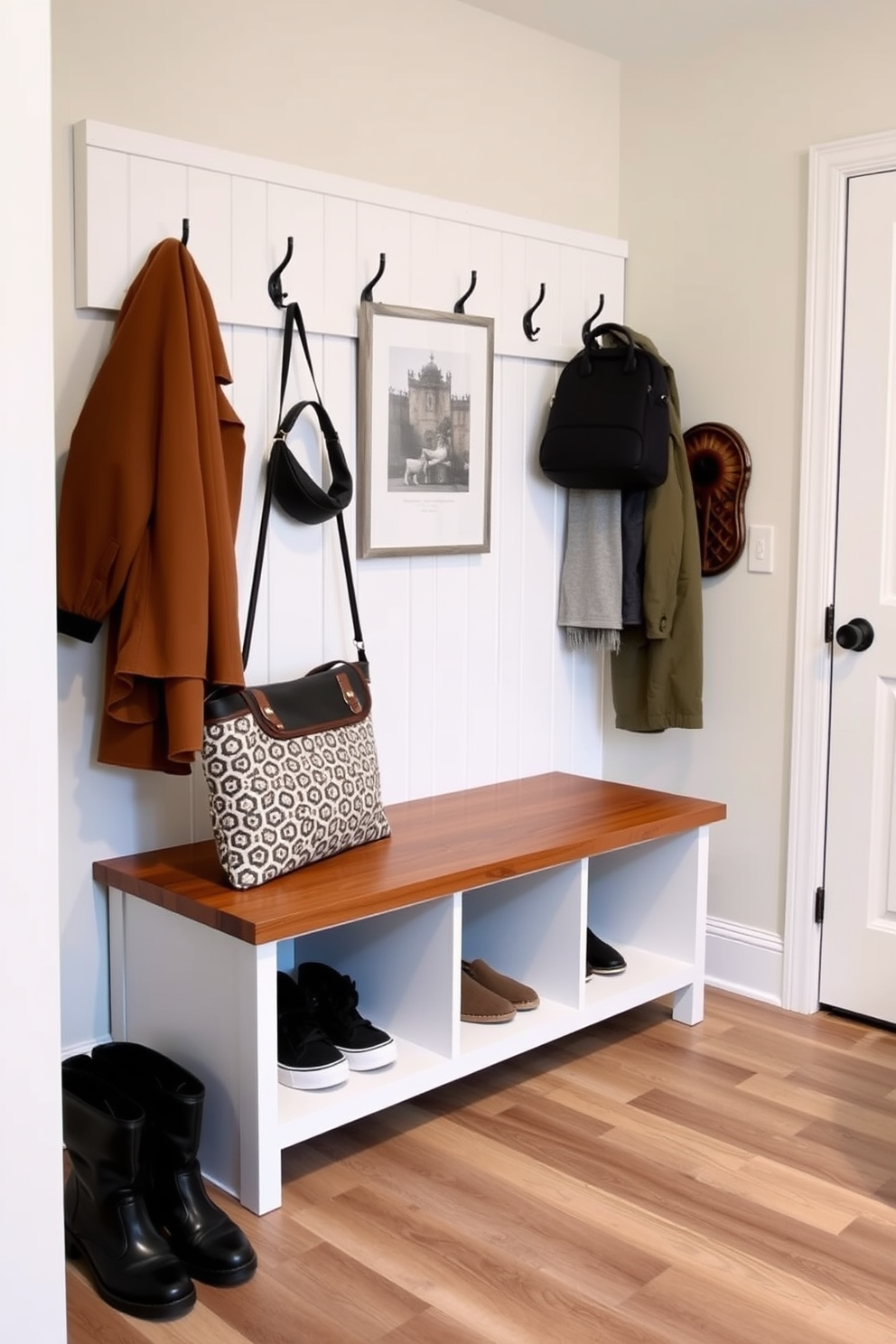 A modern mudroom featuring glass-paneled doors that invite ample natural light into the space. The room includes built-in benches with storage underneath and hooks for coats, all designed in a sleek, contemporary style.