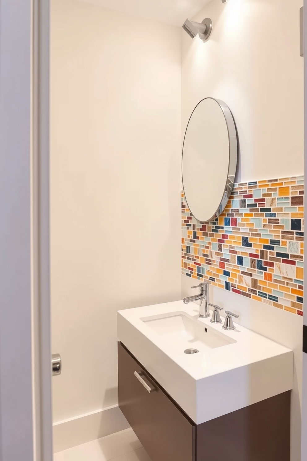 A vibrant backsplash in a modern powder room features an array of colorful tiles arranged in a geometric pattern. The walls are painted in a soft white, creating a bright and airy atmosphere that complements the lively backsplash. The powder room includes a sleek floating vanity with a polished chrome faucet and a round mirror above it. Accent lighting highlights the backsplash, adding depth and character to the overall design.