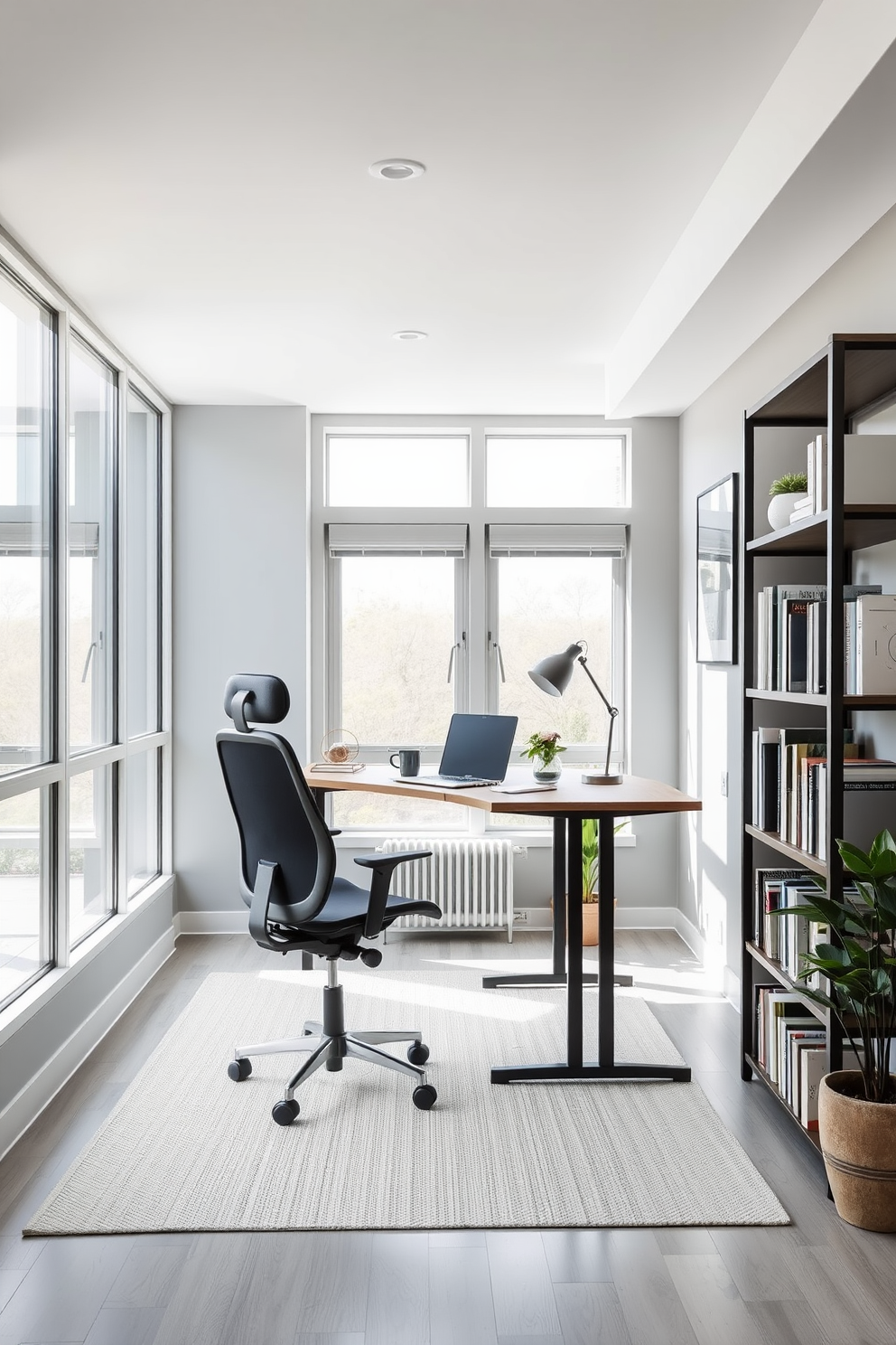 A modern study room featuring a standing desk option. The room is bright and airy with large windows allowing natural light to flood in, complemented by a sleek ergonomic chair and minimalist decor. The walls are painted in a soft gray hue, enhancing the room's tranquility. A stylish bookshelf filled with books and decorative items lines one side, while a potted plant adds a touch of greenery to the space.