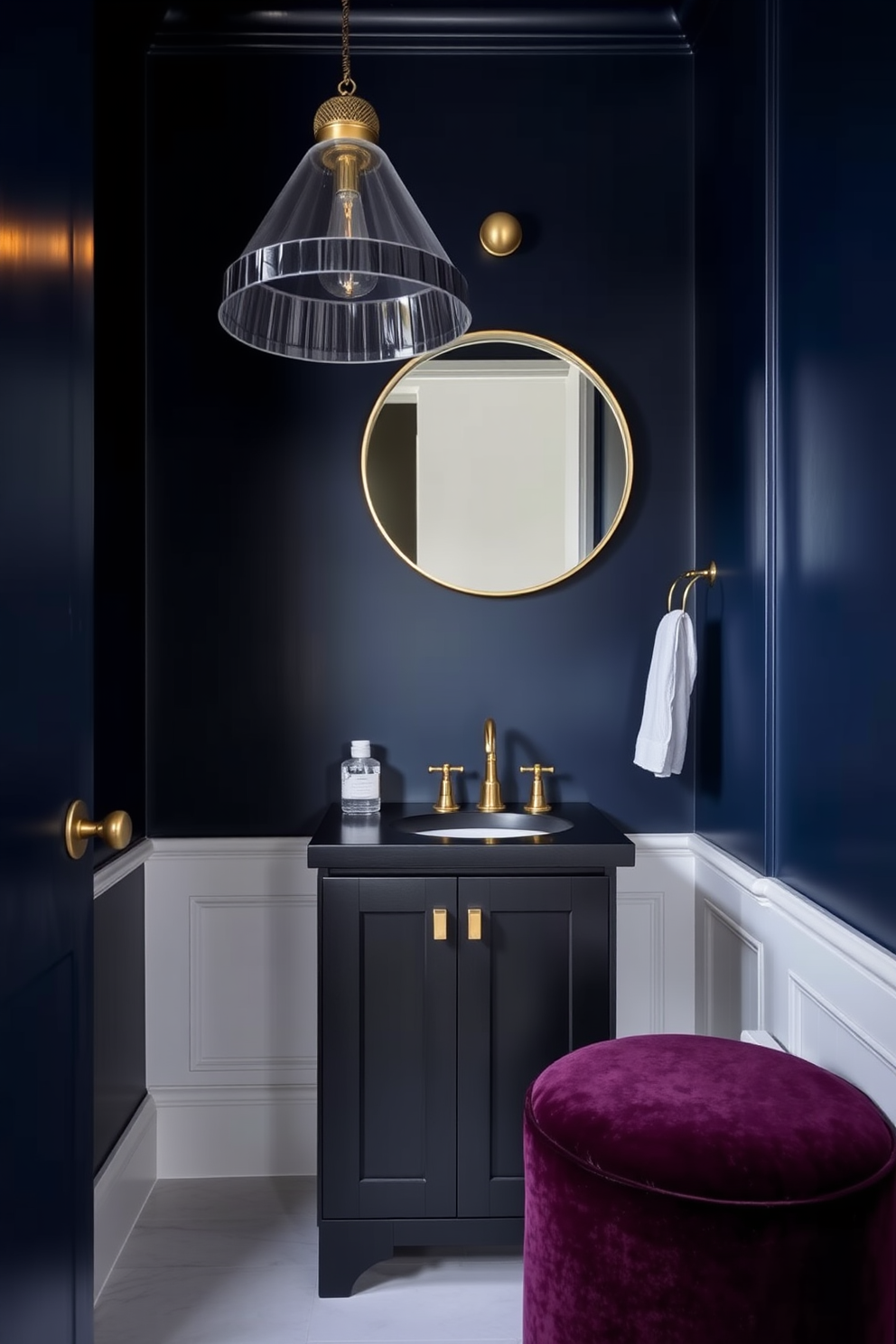 A dark wood vanity with gold accents creates an elegant focal point in a moody powder room. The walls are painted in a deep navy blue, and the lighting is soft and ambient, enhancing the luxurious atmosphere.