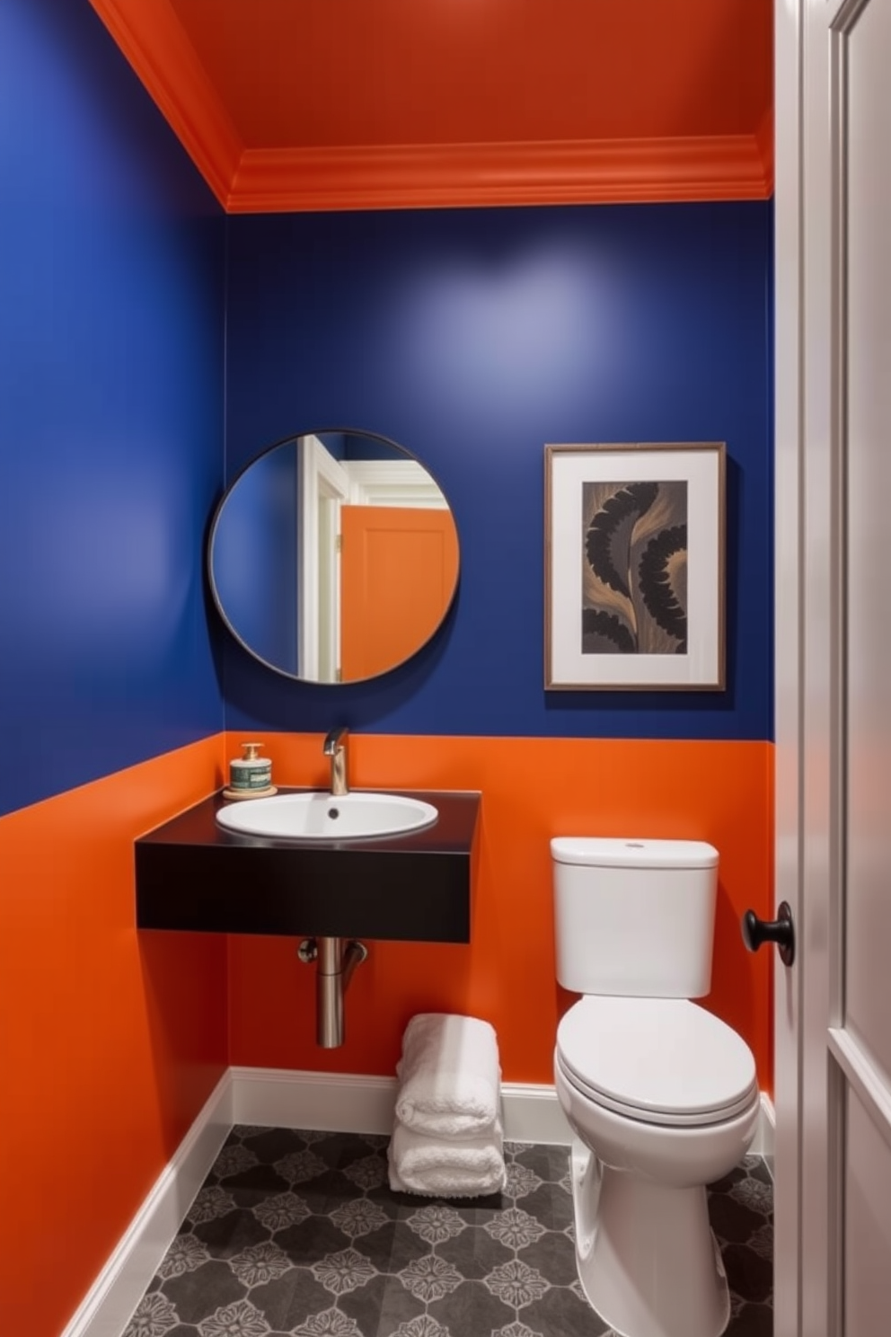 A bold powder room featuring striking color blocking with deep blue and vibrant orange walls. The space is accented with a sleek black vanity and a large round mirror that reflects the dramatic hues.