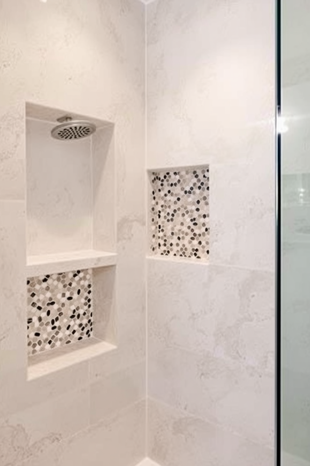 A serene bathroom design featuring neutral tone mosaic shower niches. The walls are adorned with elegant mosaic tiles in soft beige and taupe, creating a harmonious and inviting atmosphere.