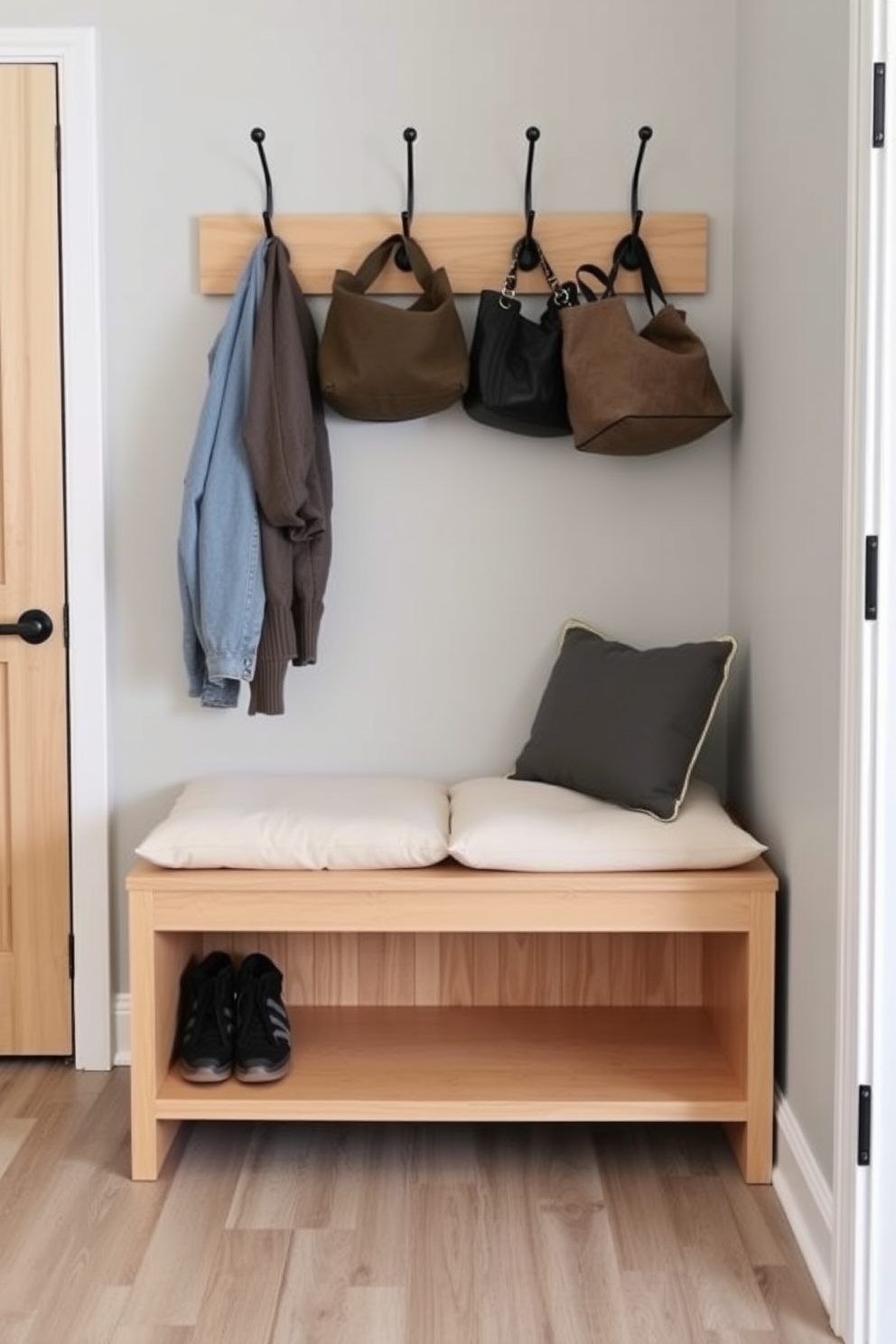 A mudroom featuring a bench with a reclaimed wood finish that adds warmth and character to the space. The bench is complemented by hooks for coats and a storage area underneath for shoes, creating a functional yet stylish entryway.