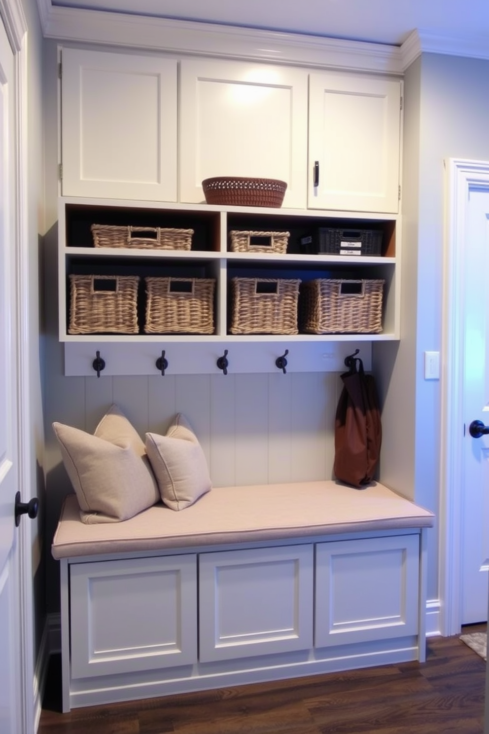 A stylish mudroom features a bench with a sliding door storage unit underneath. The bench is upholstered in a soft fabric and complemented by decorative cushions for added comfort.