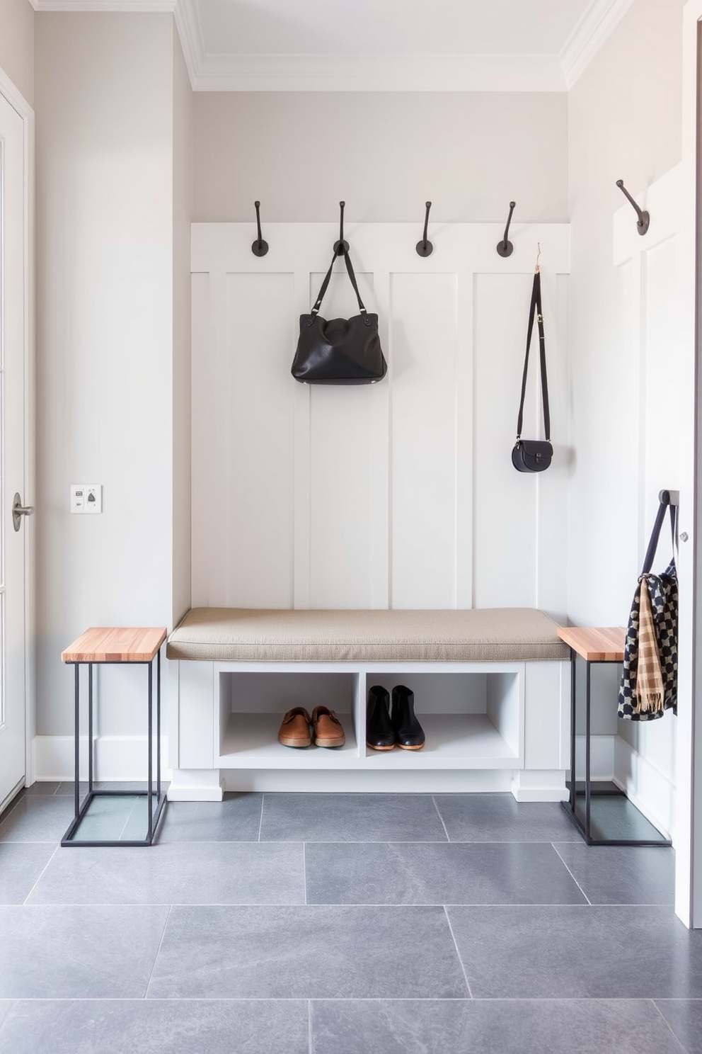 A stylish mudroom featuring a built-in bench with a comfortable backrest and plush cushions for added comfort. The bench is flanked by storage cubbies for shoes and outdoor gear, with a backdrop of shiplap walls painted in a soft gray hue.