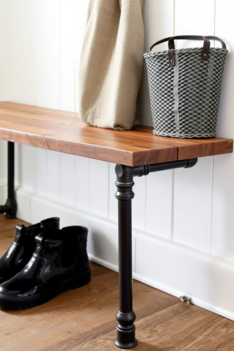 A stylish mudroom featuring a wooden bench with built-in storage underneath. Behind the bench, a large chalkboard wall serves as a practical and decorative backdrop for notes and family schedules.