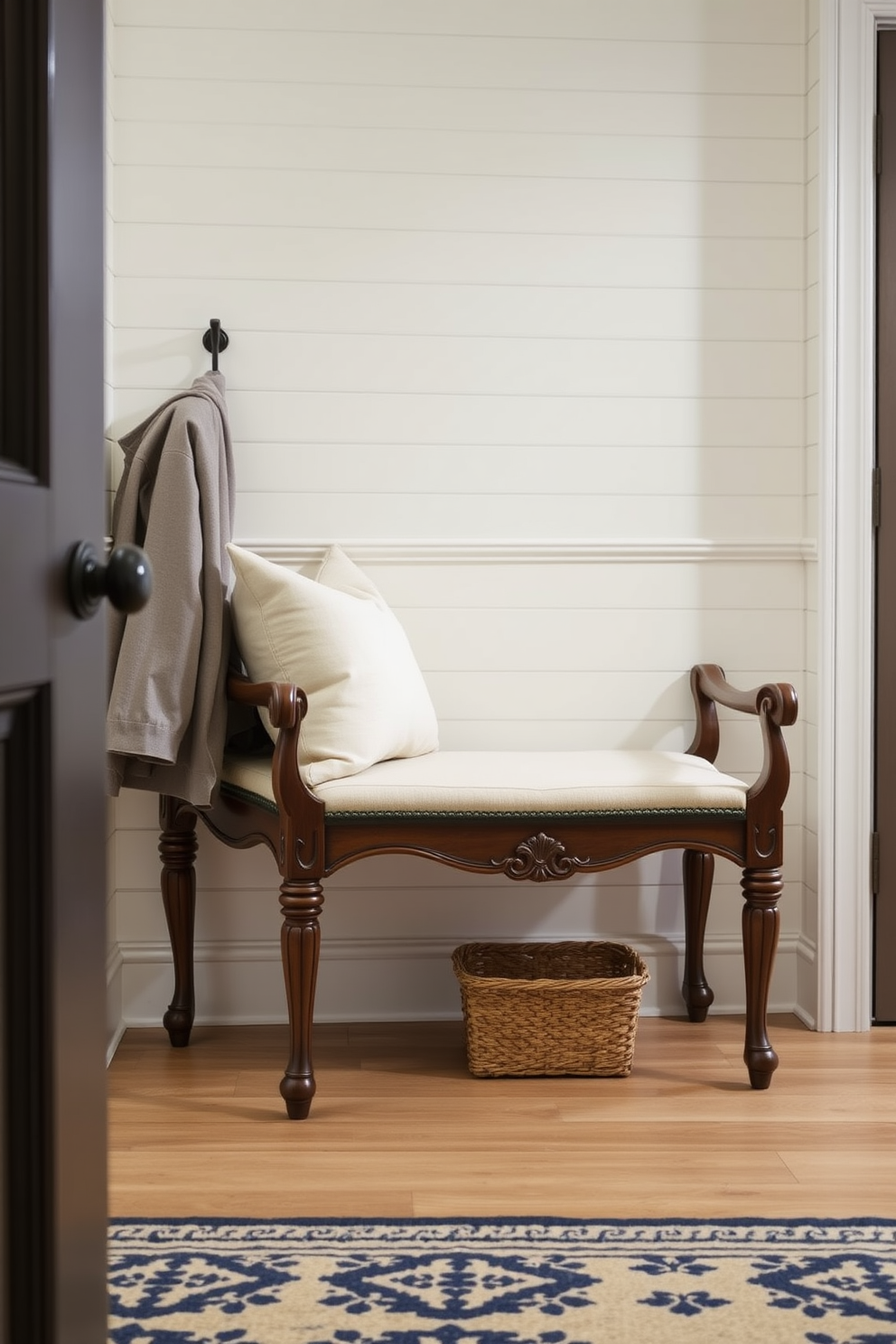 A stylish mudroom features a bench with a hidden drawer for storing keys. The bench is upholstered in a soft fabric and is complemented by decorative pillows in coordinating colors.