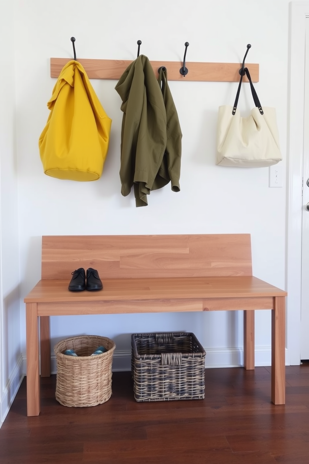 A classic mudroom bench features elegant molding details that enhance its timeless appeal. The bench is adorned with plush cushions and surrounded by hooks for hanging coats and bags, creating a functional yet stylish entryway.