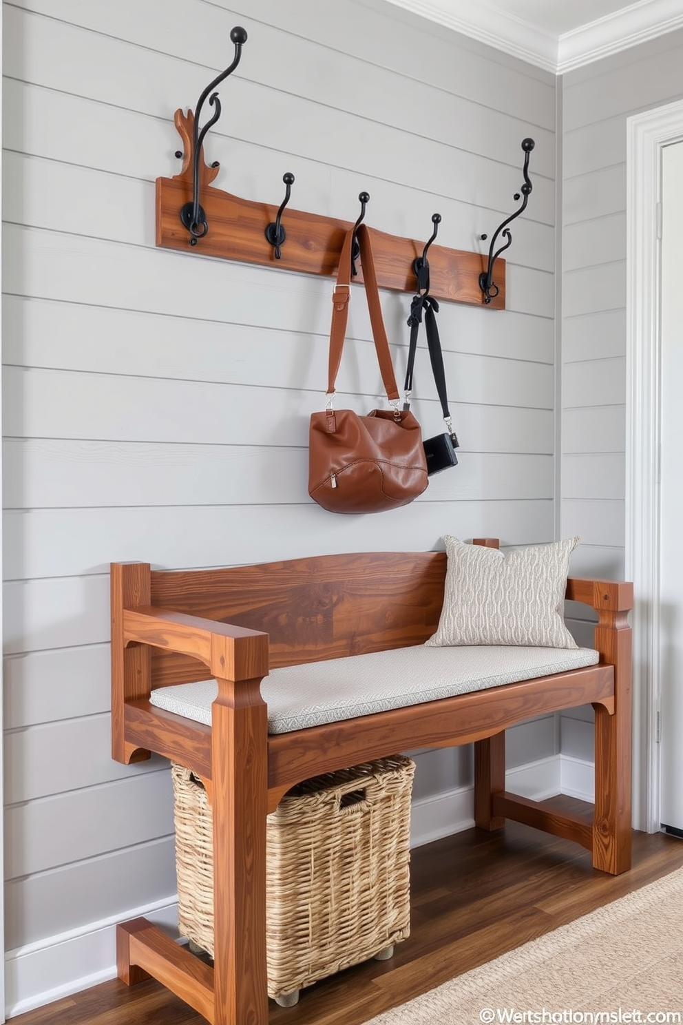 A stylish mudroom features a bench with a striking geometric design pattern that serves as a functional focal point. The bench is upholstered in a durable fabric, providing comfort while adding a contemporary touch to the space. On one side of the bench, there are built-in cubbies for storage, neatly organizing shoes and accessories. The walls are adorned with hooks for hanging coats, creating an efficient and inviting entryway.