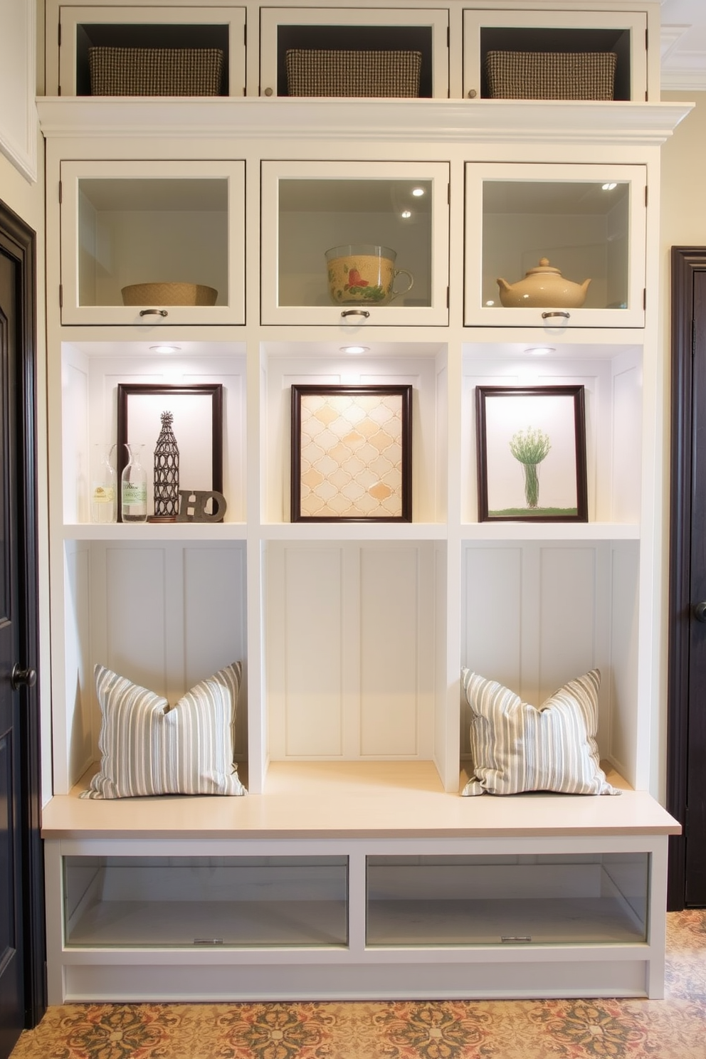 A functional mudroom featuring glass-fronted cubbies designed for displaying decorative items. The cubbies are arranged in a symmetrical layout with a stylish bench below, accented by soft cushions for comfort.