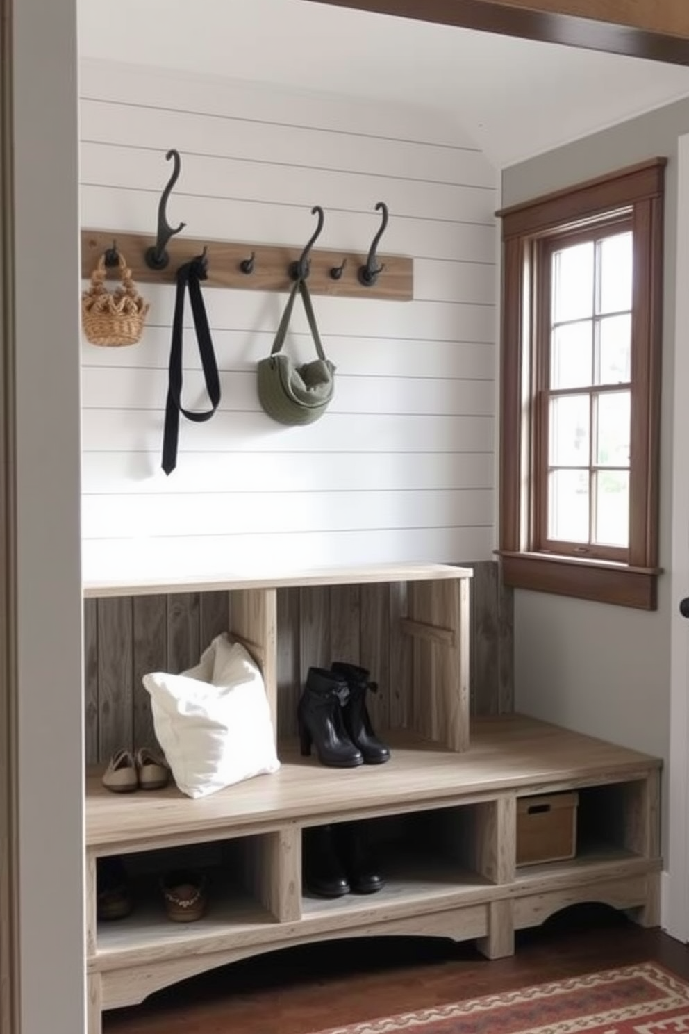 A cozy mudroom featuring farmhouse style wooden cubbies with a distressed finish. Each cubby is spacious enough to hold shoes and bags, while a bench below provides seating for easy access. The walls are adorned with shiplap, and a large window allows natural light to flood the space. Rustic hooks are mounted above the cubbies for hanging coats and accessories, adding to the charm.