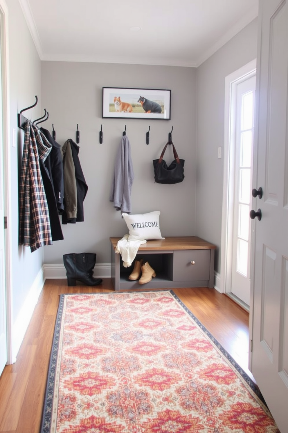 A functional folding table is positioned against the wall in the mudroom, offering additional workspace and storage. The table features a sleek design with a natural wood finish, complemented by a pair of stylish stools tucked underneath. The mudroom is designed with built-in cubbies for shoes and coats, finished in a soft gray color. A bench with plush cushions provides a comfortable spot for putting on or taking off footwear, while hooks above offer convenient storage for bags and jackets.